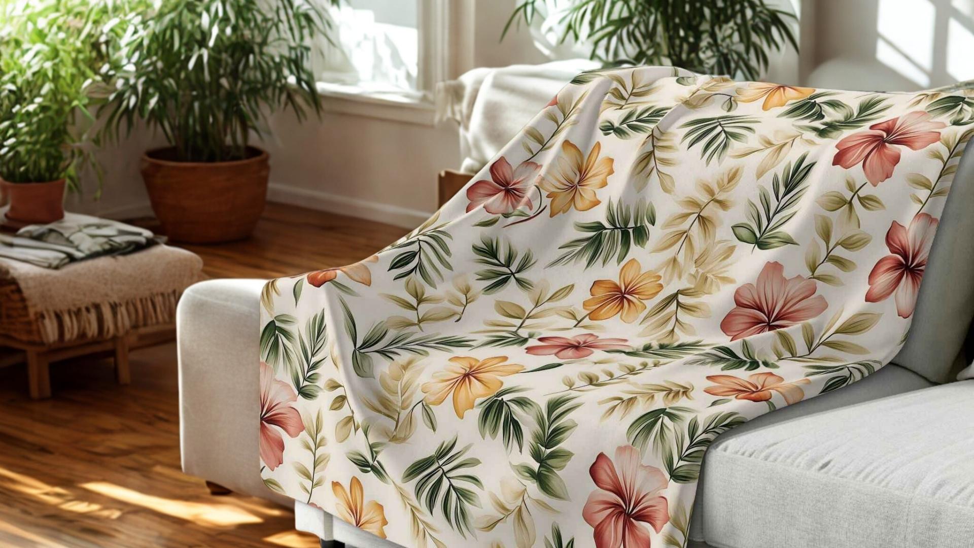 Hibiscus Blanket laying on couch in a living room.