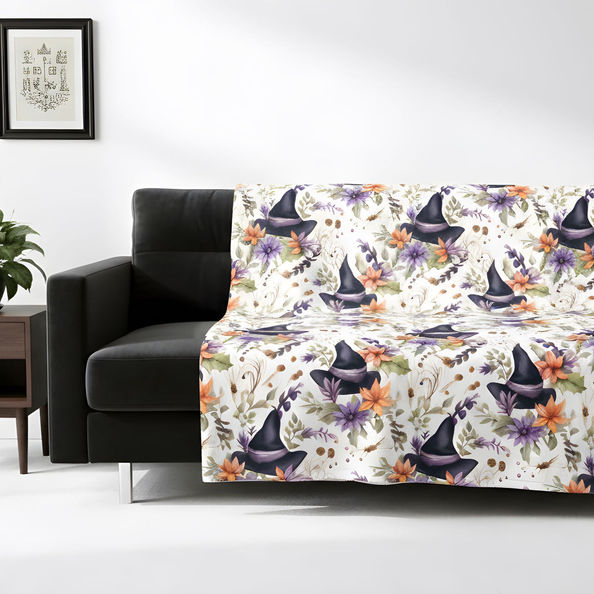 Halloween-inspired witch hat blanket displayed over a black sofa in a bright room.
