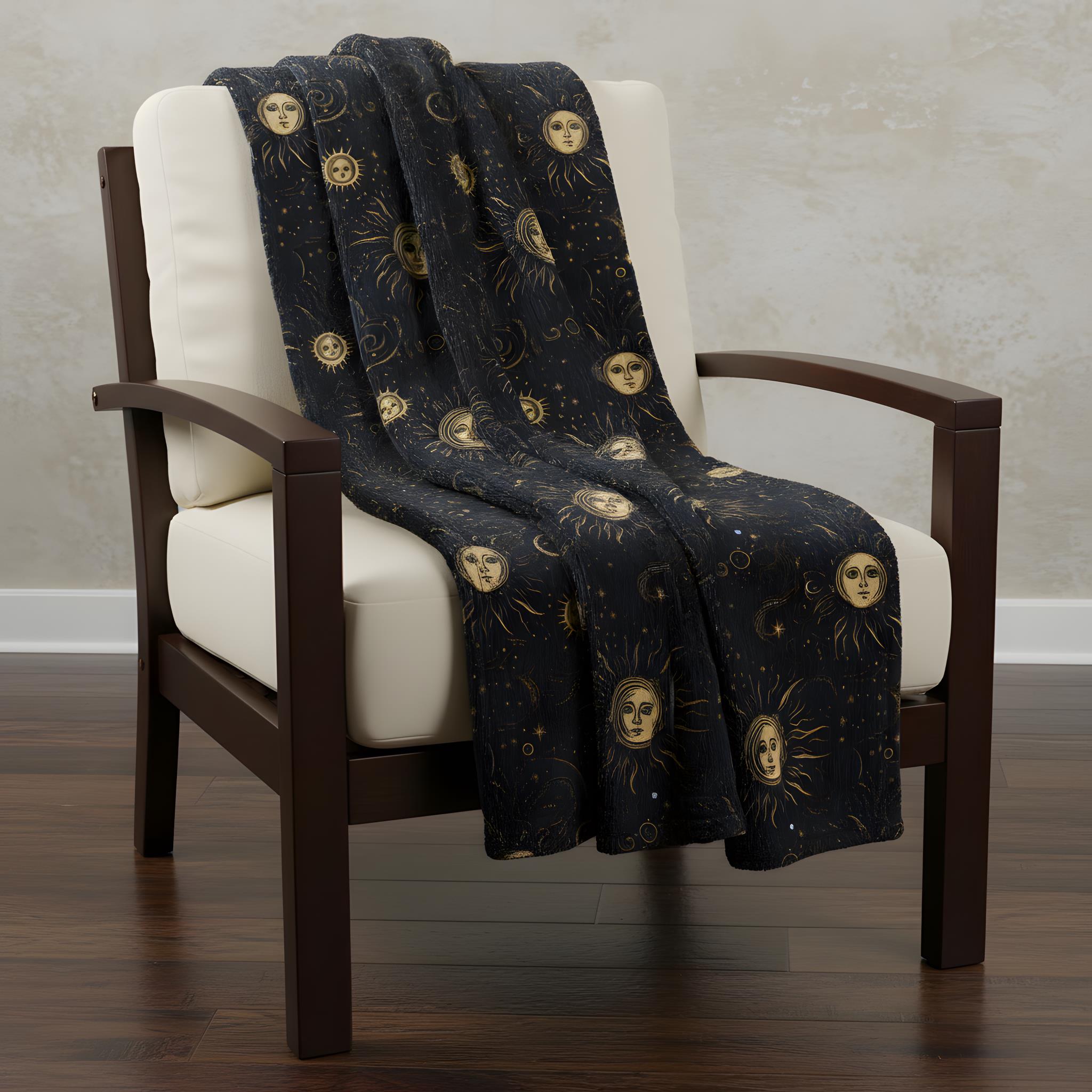 A whimsigoth celestial throw blanket on a beige and wooden chair.