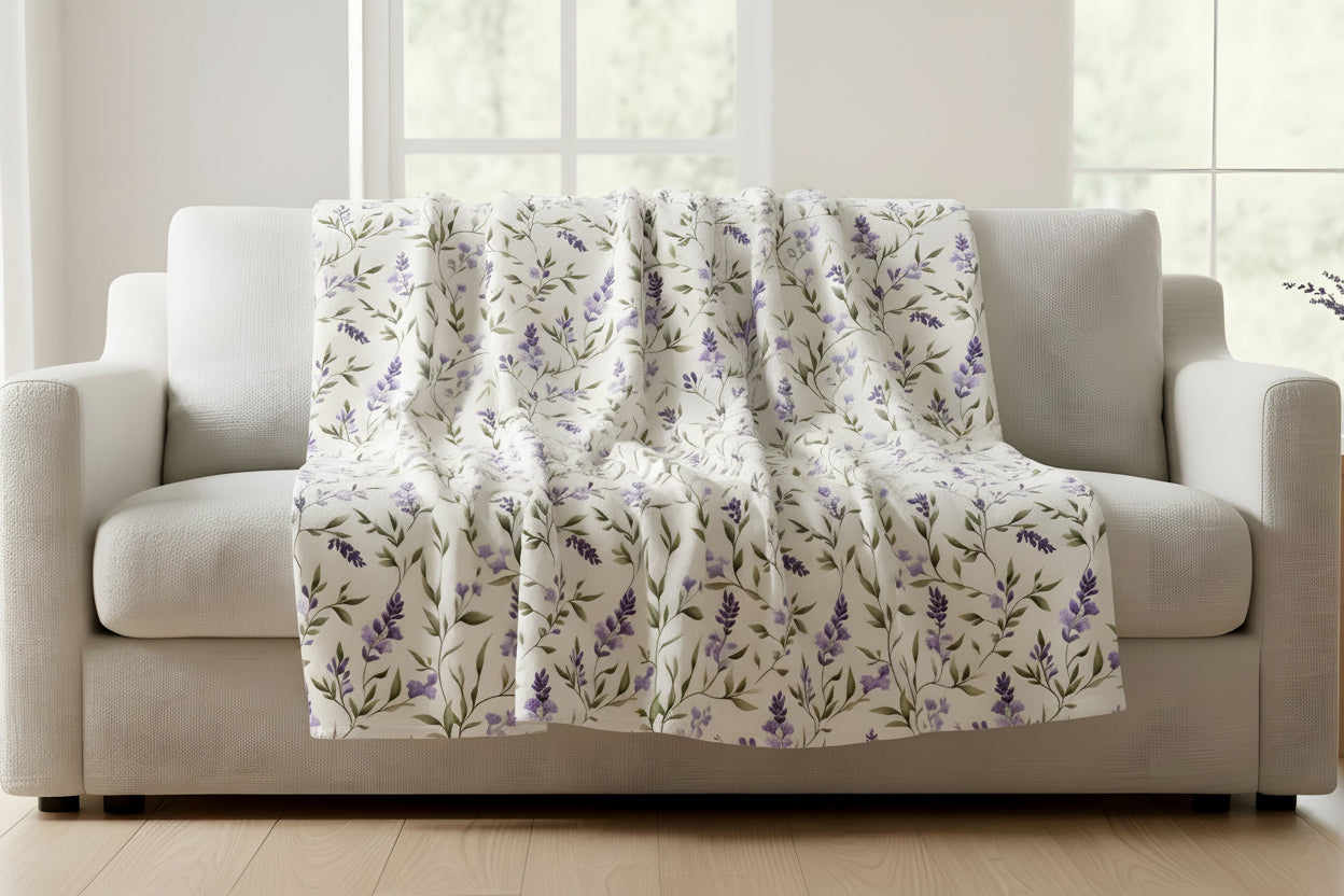 Purple floral-patterned blanket draped over a gray sofa for spring aesthetic.