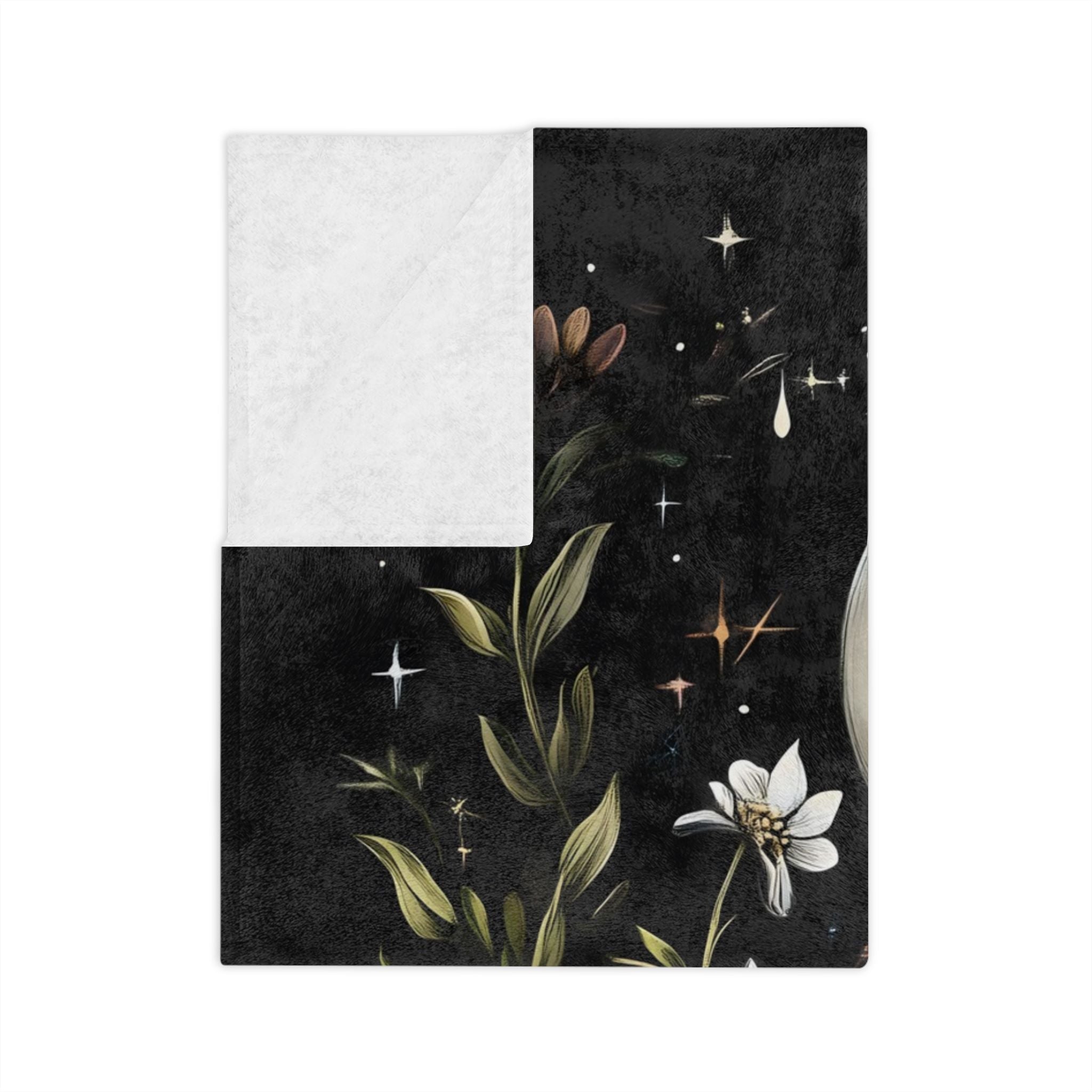 Black velveteen throw blanket folded with crescent moon, and dark florals with white backing.