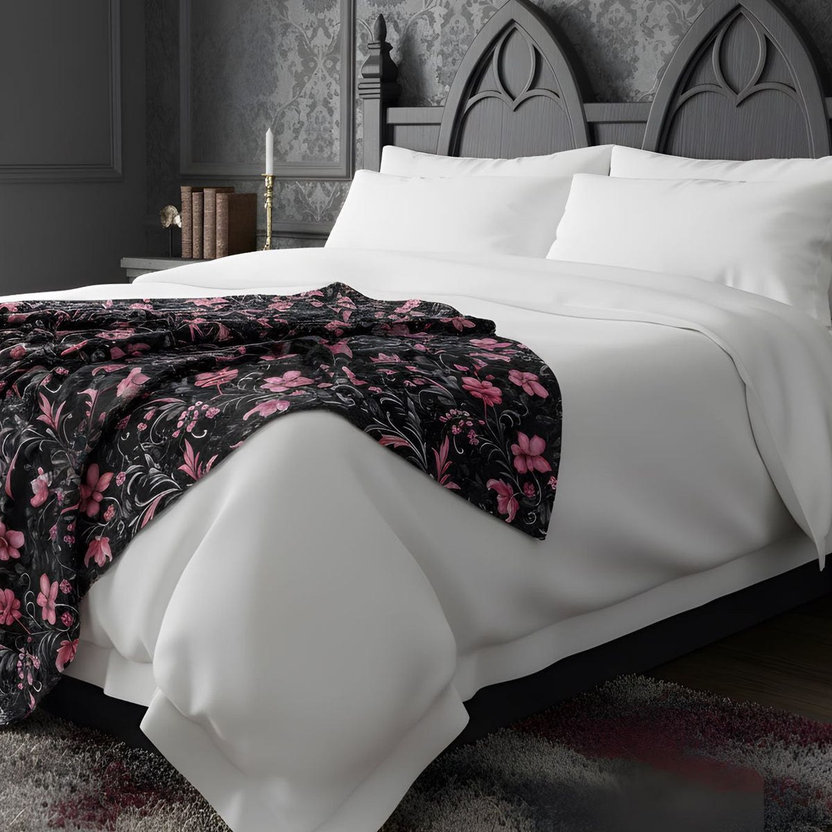 A pink floral throw blanket in a moody bedroom.