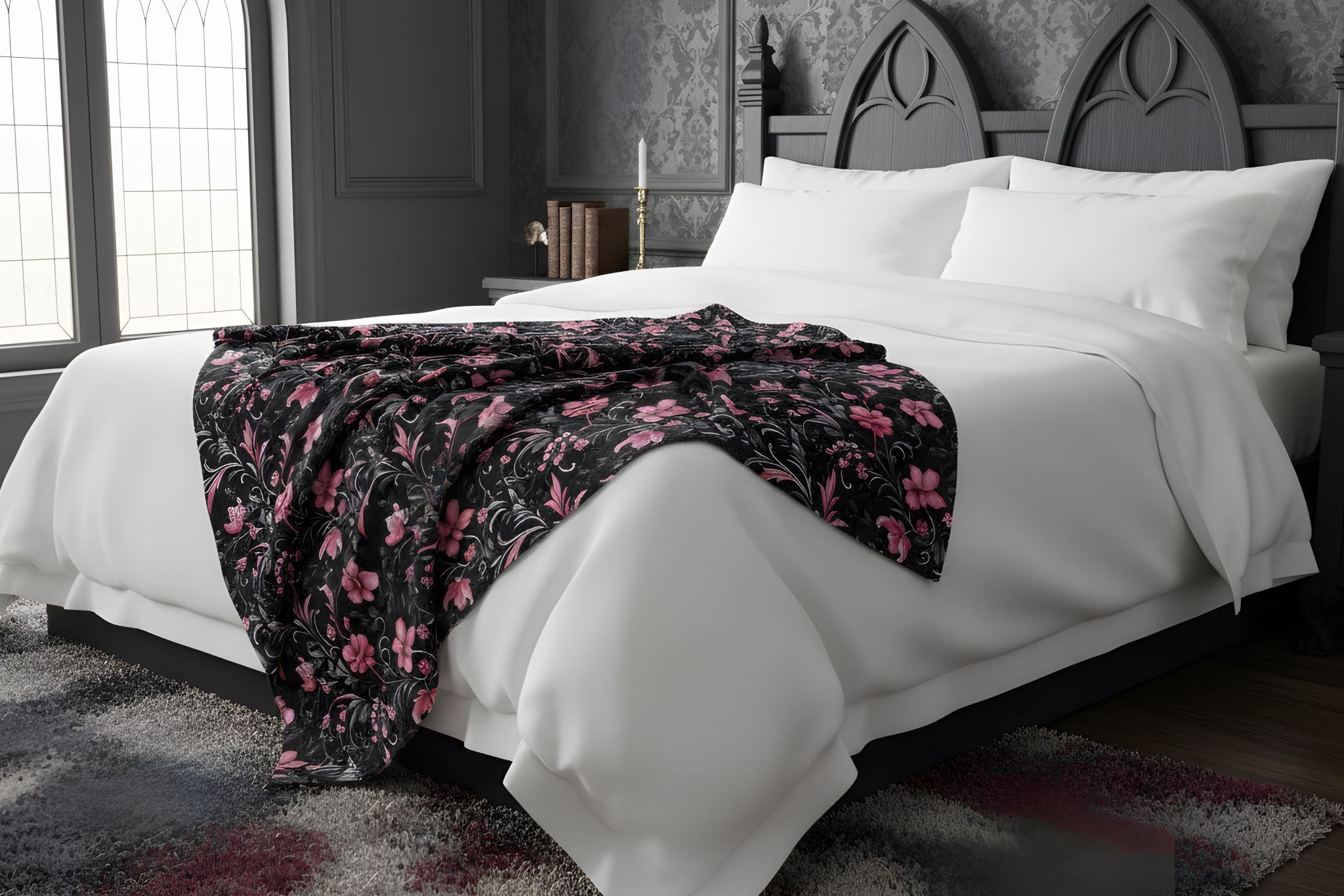 A pink floral throw blanket in a moody bedroom.