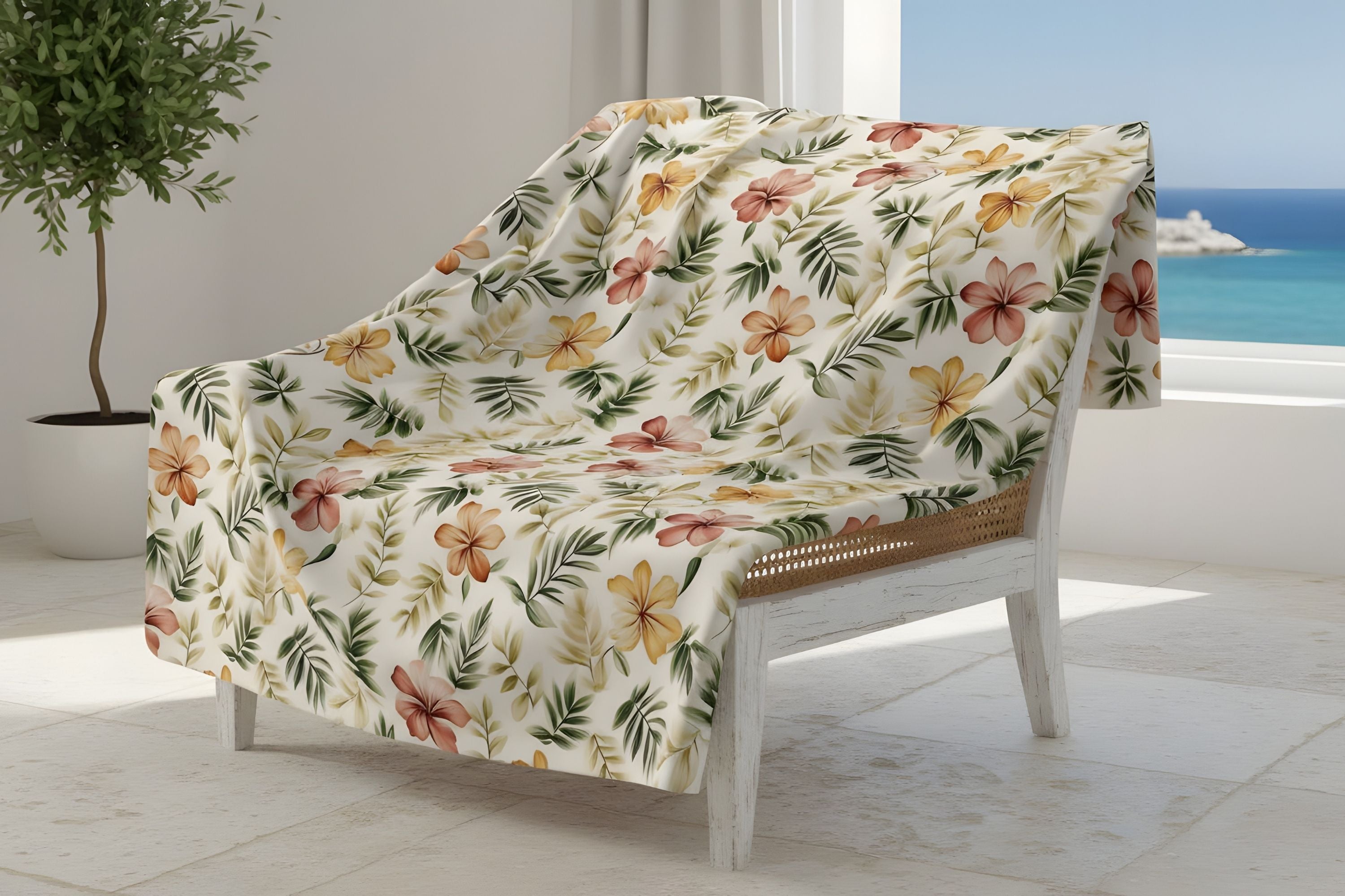 Coastal Mediterranean velveteen or sherpa throw blanket with tropical hibiscus print on accent chair.