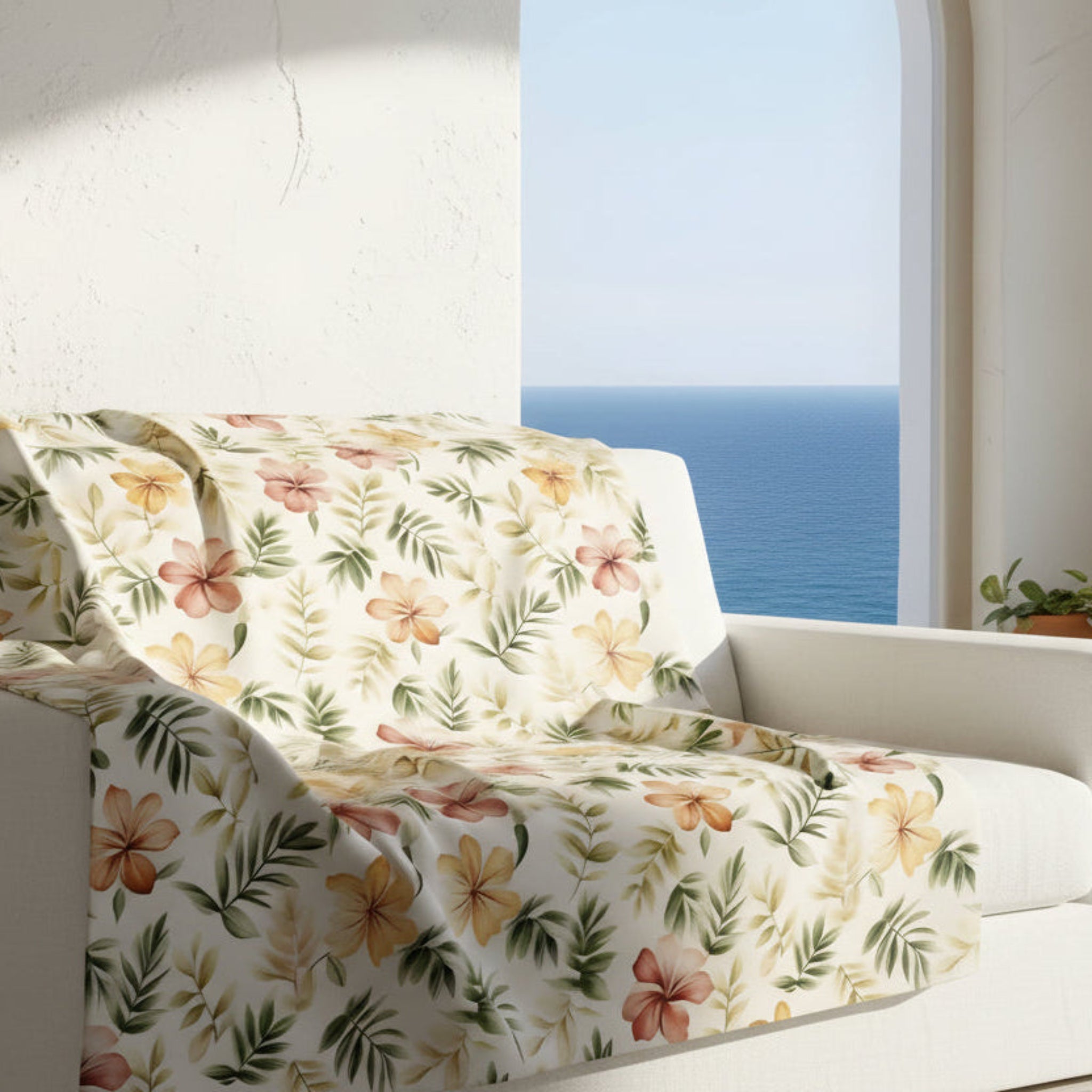 Coastal Mediterranean throw blanket on sofa with soft kibiscus floral print in velveteen or sherpa.