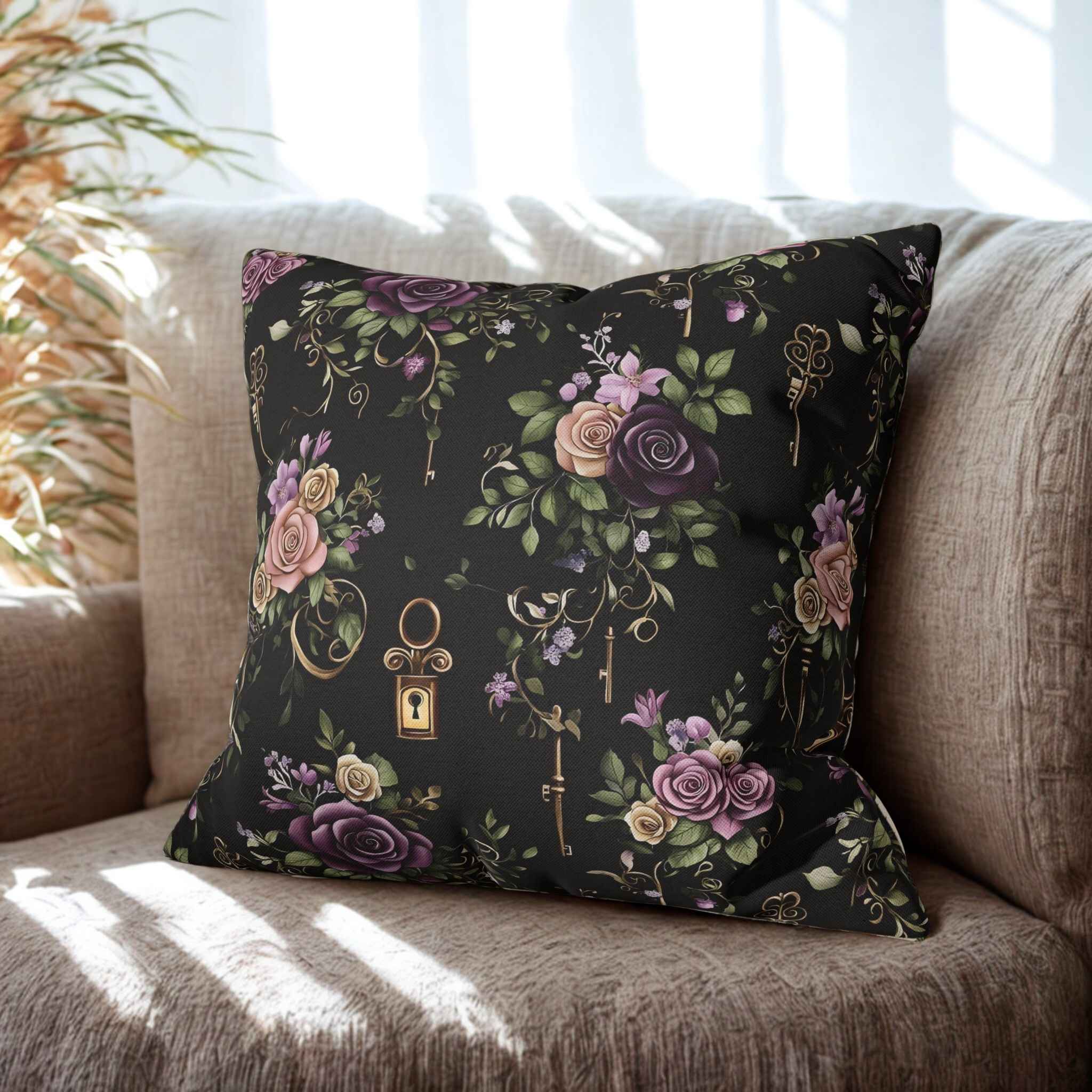 A square-shaped throw pillow with a gothic floral pattern and antique keys design, displayed on a sofa.