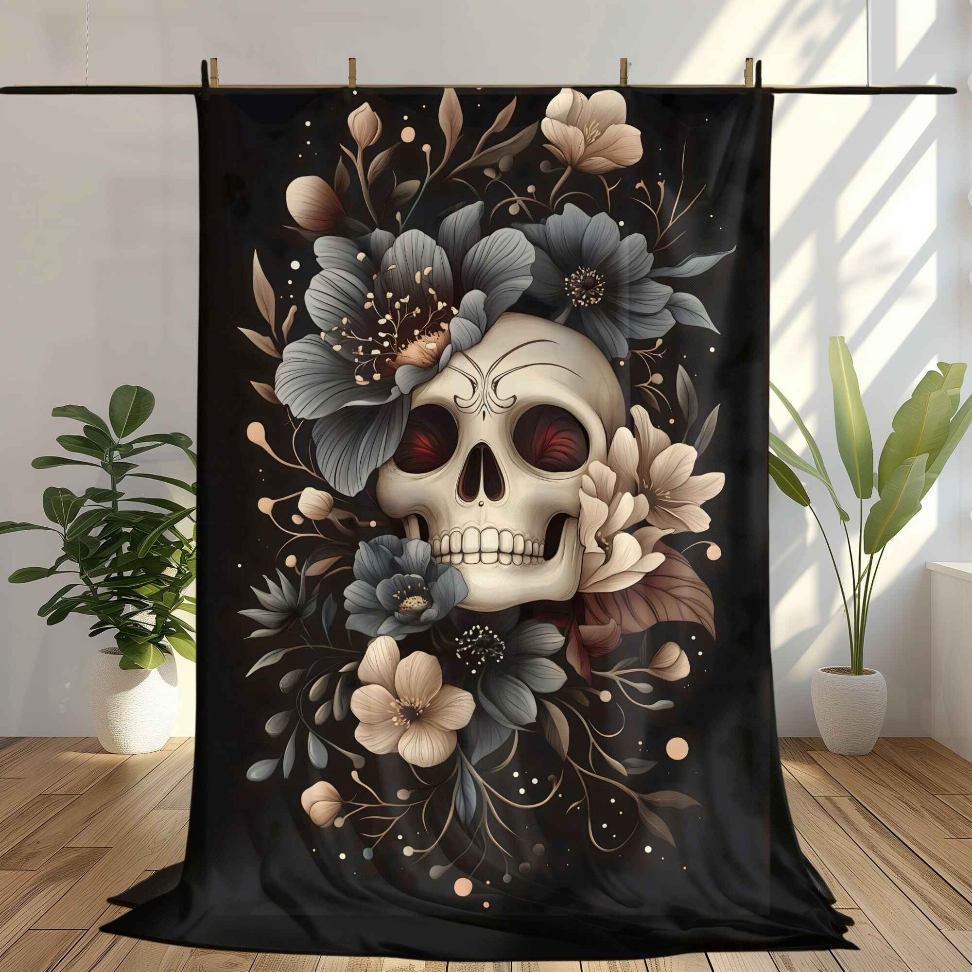 A throw blanket featuring a floral skull design with blue flowers on a dark background, displayed in a home decor setting.