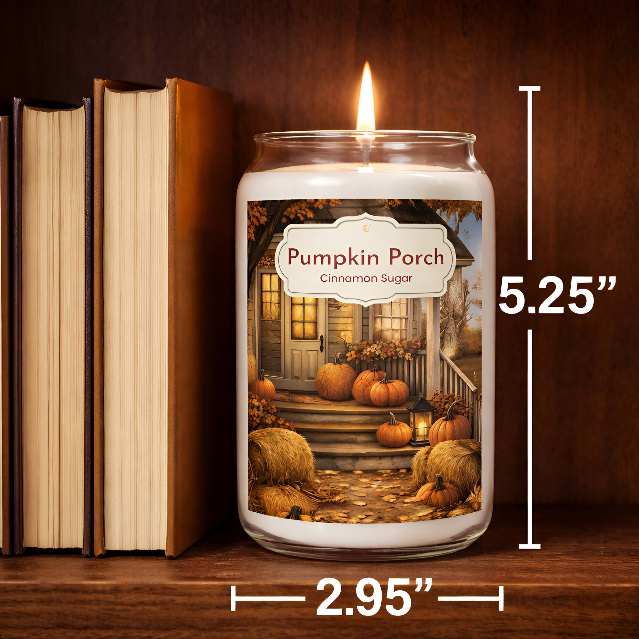 Cinnamon and sugar scened candle labeled 'Pumpkin Porch' with dimensions displayed, next to books on a wooden shelf.