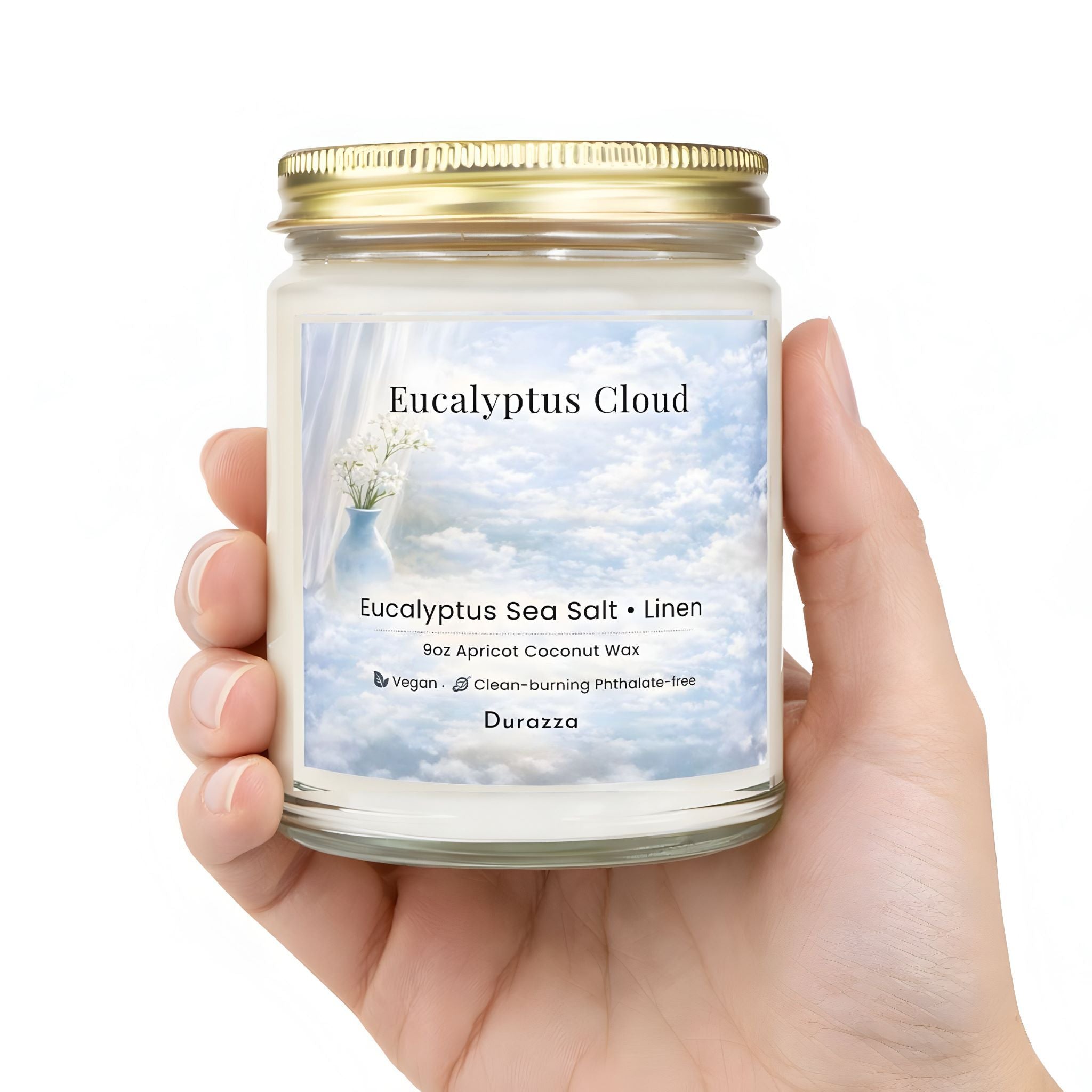 Hand holding a spa scented candle labeled 'Eucalyptus Cloud' by Durazza.