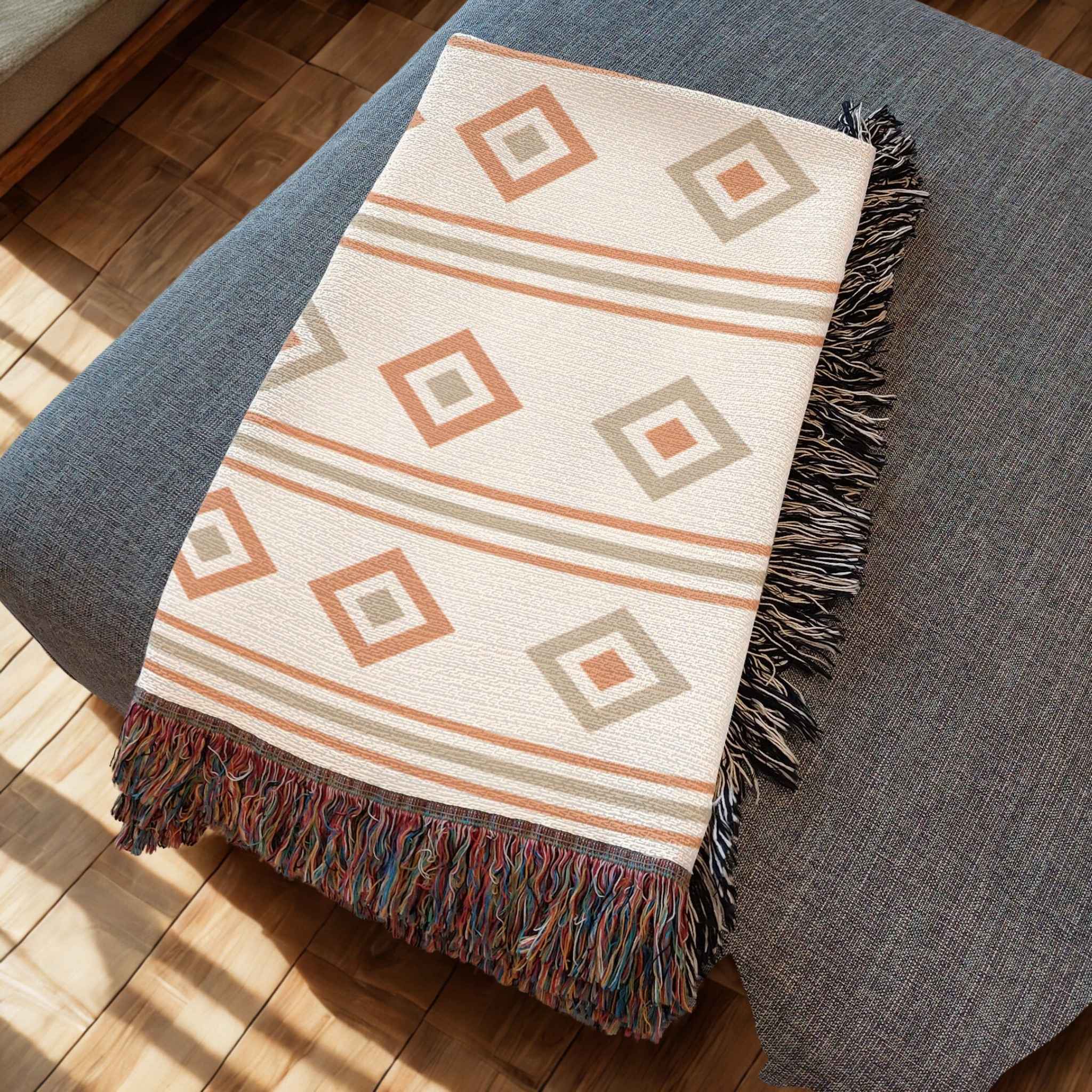 Decorative throw blanket with geometric pattern on a gray surface