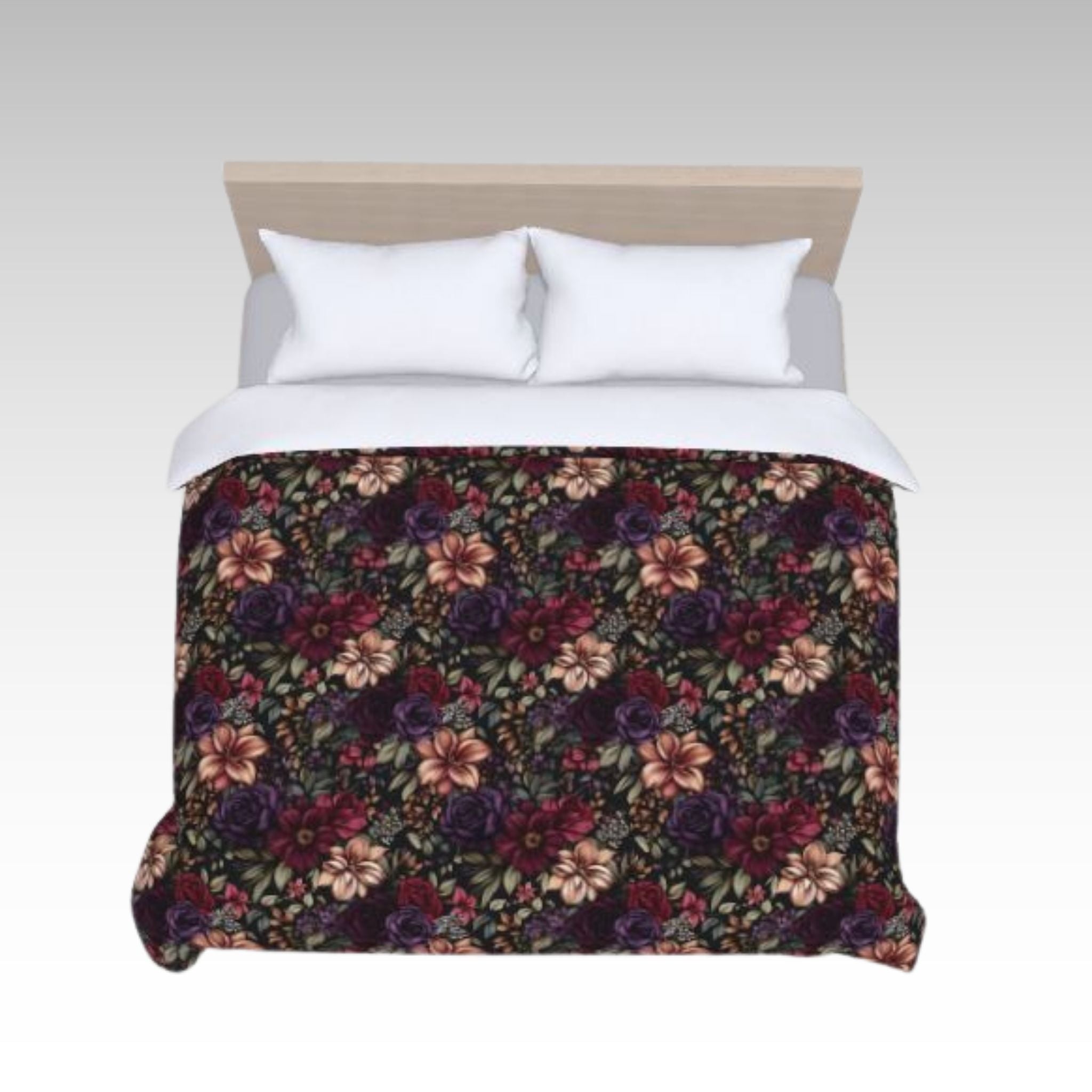 Top view of dark floral duvet cover on a bed with white pillows.
