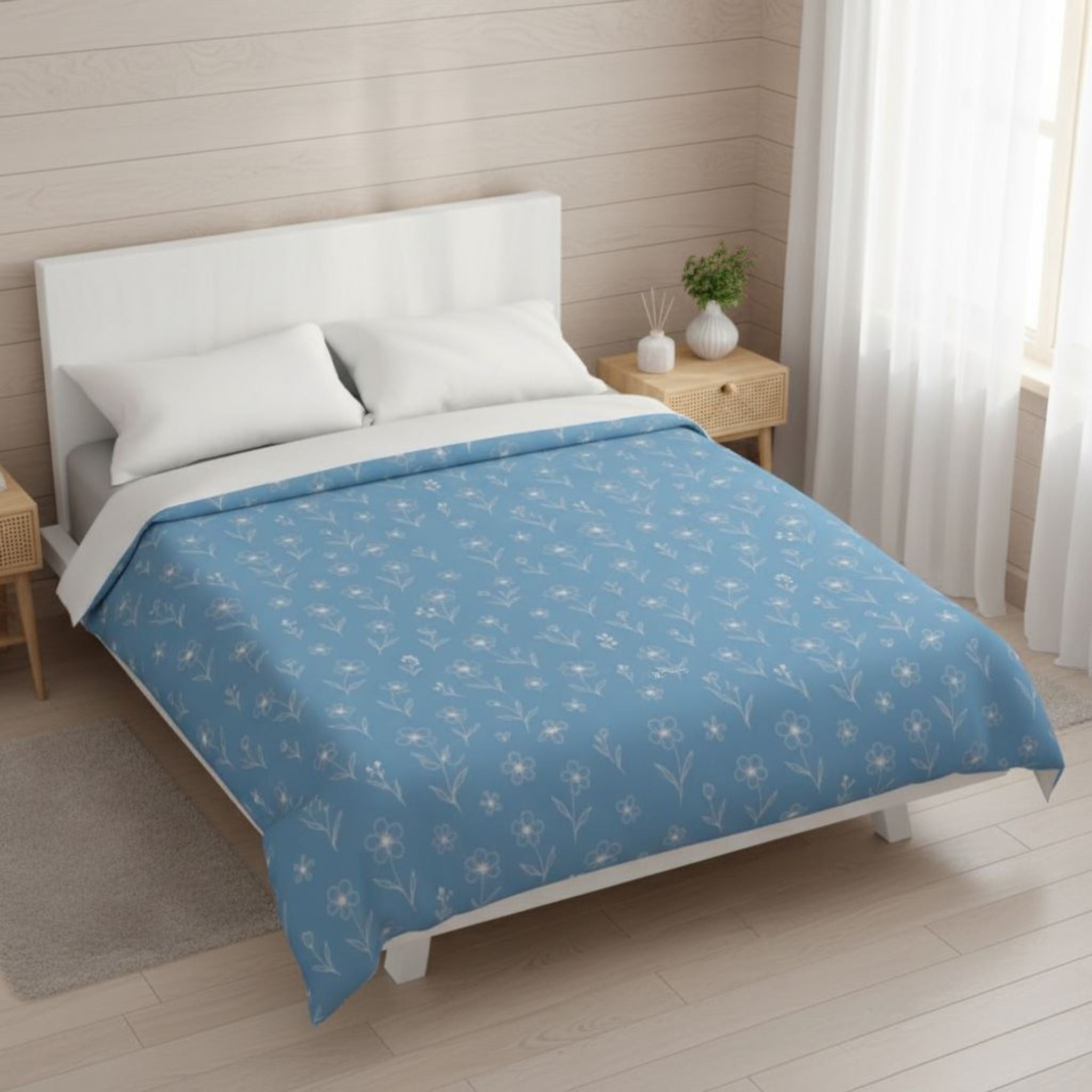 Bed with blue floral-patterned duvet cover in a bedroom setting
