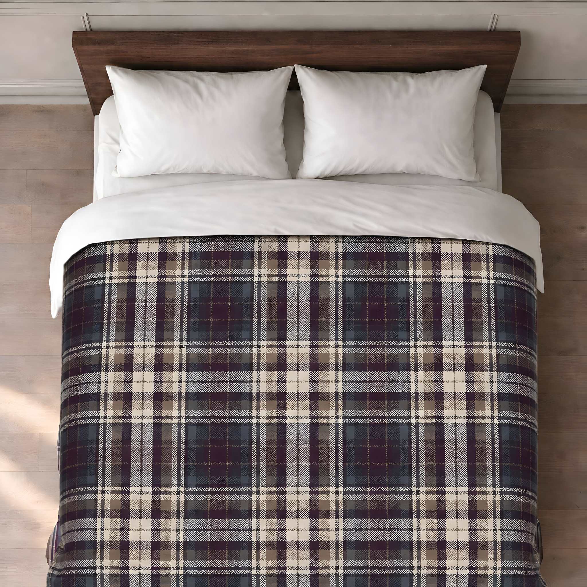 A bed with a herringbone plaid cotton duvet cover in dark navy, burgundy, beige, and gray tones, styled with two white pillows and white bedding, set against a dark wood headboard.