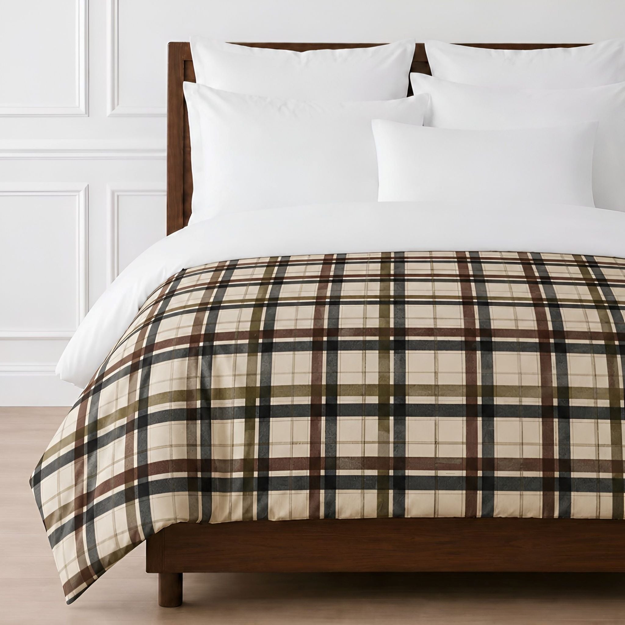 A plaid comforter in beige, brown, and black with white pillows and white duvet, displayed on a wooden bed frame against a white paneled wall.