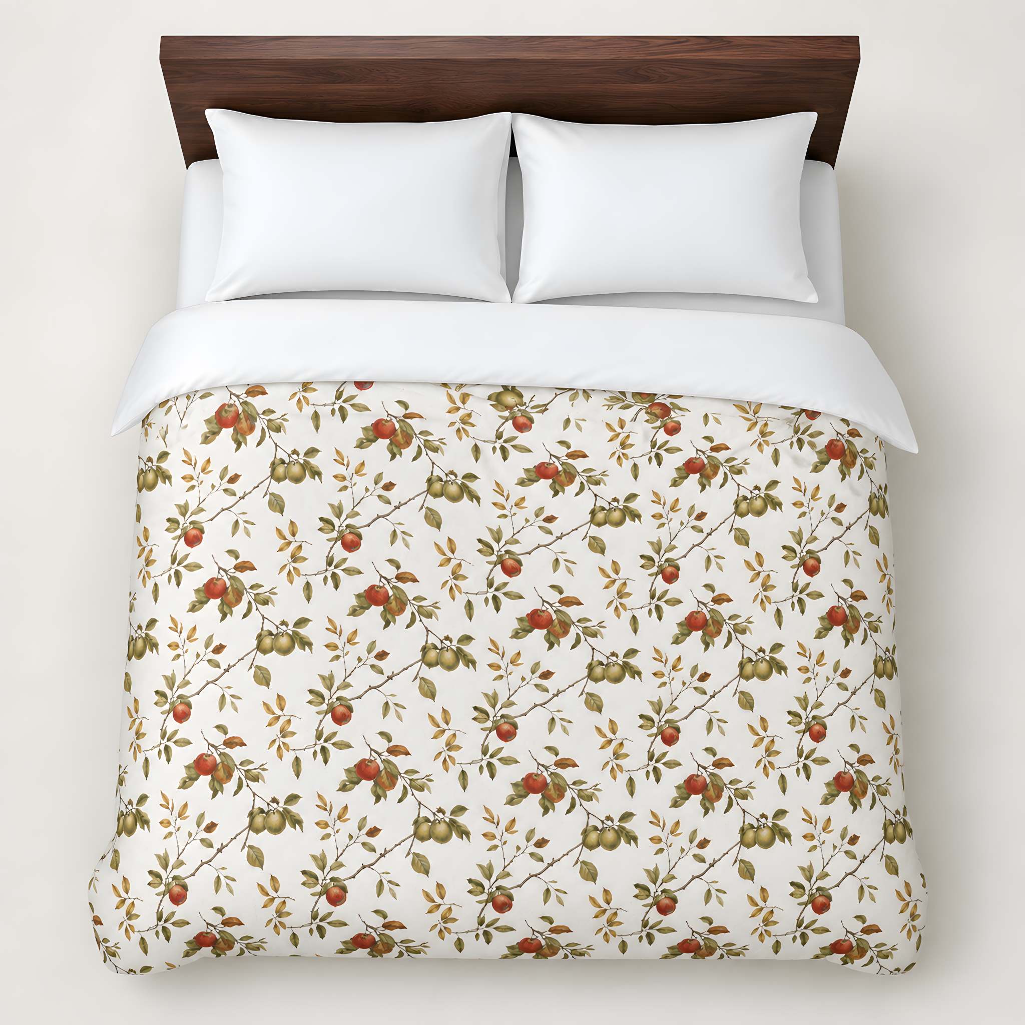A top-down view of a bed dressed in a cream duvet cover with a vintage-style botanical pattern of red apples and green leaves, styled with two white pillows and a dark wood headboard against a light beige wall.
