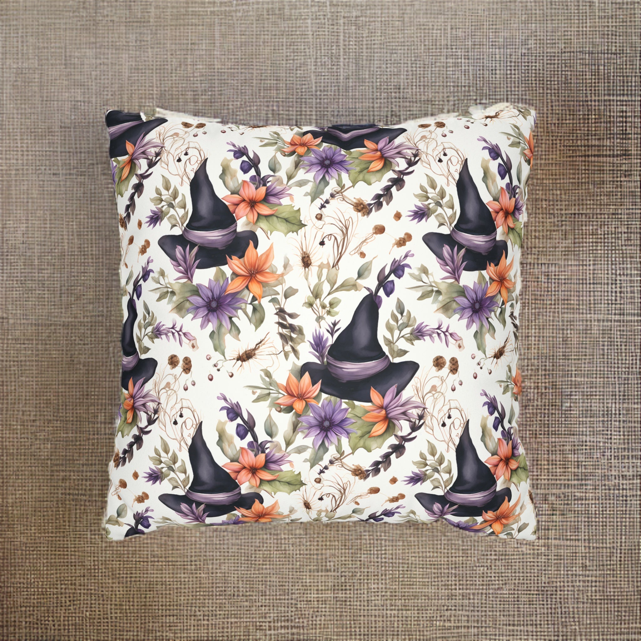A woven polyester pillow cover featuring a watercolor floral pattern with a witch motif in purple, orange, and black colors on a white background.