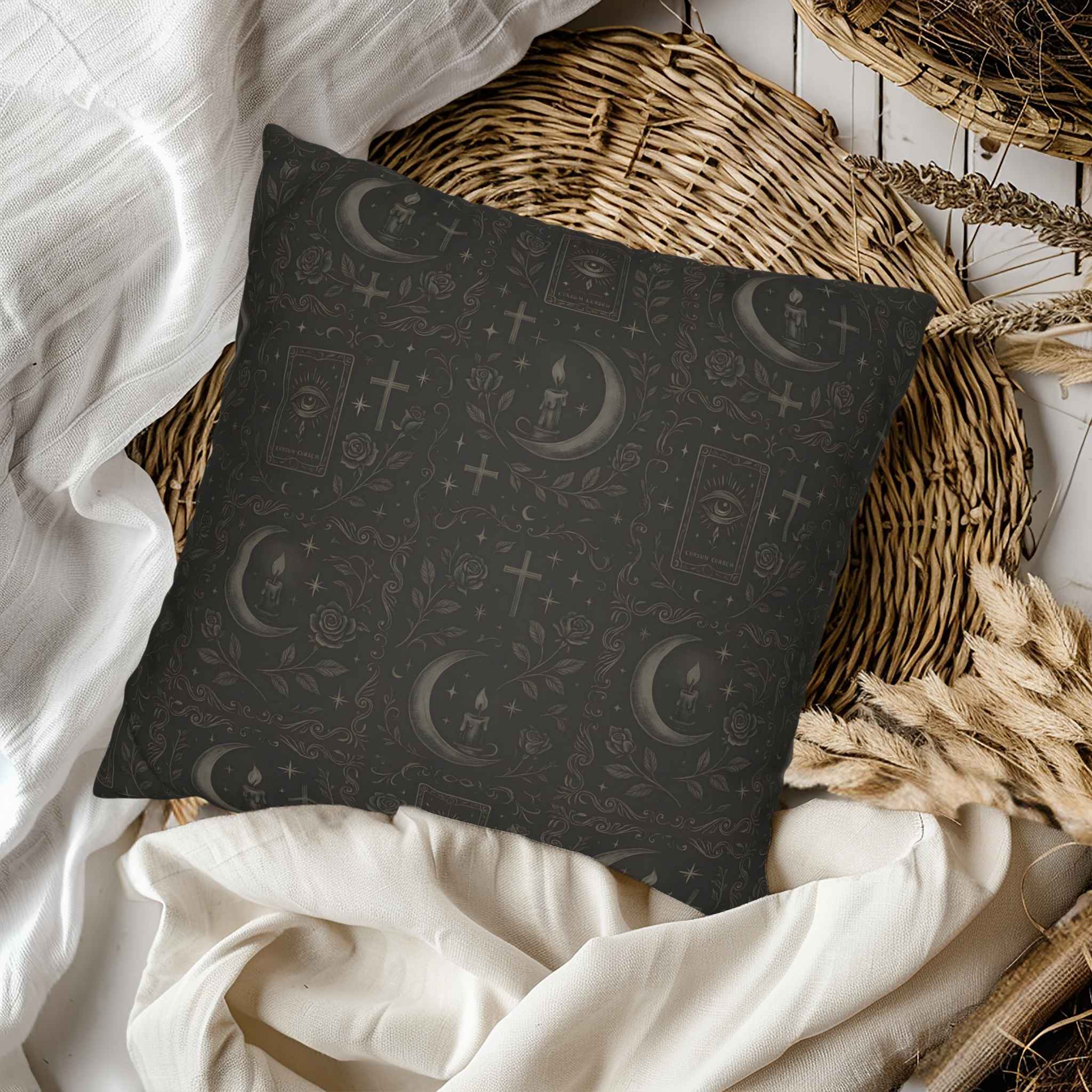 Decorative pillow with celestial pattern on a bed with white bedding and wicker basket.