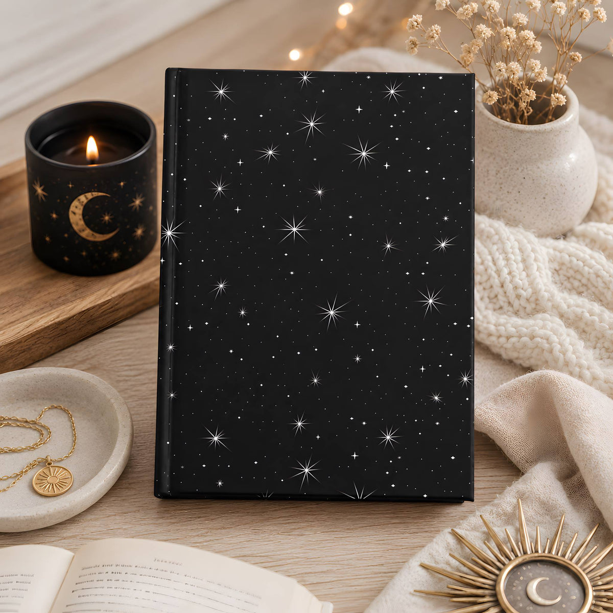 Whimsigoth notebook with star pattern on a wooden surface with decorative items.