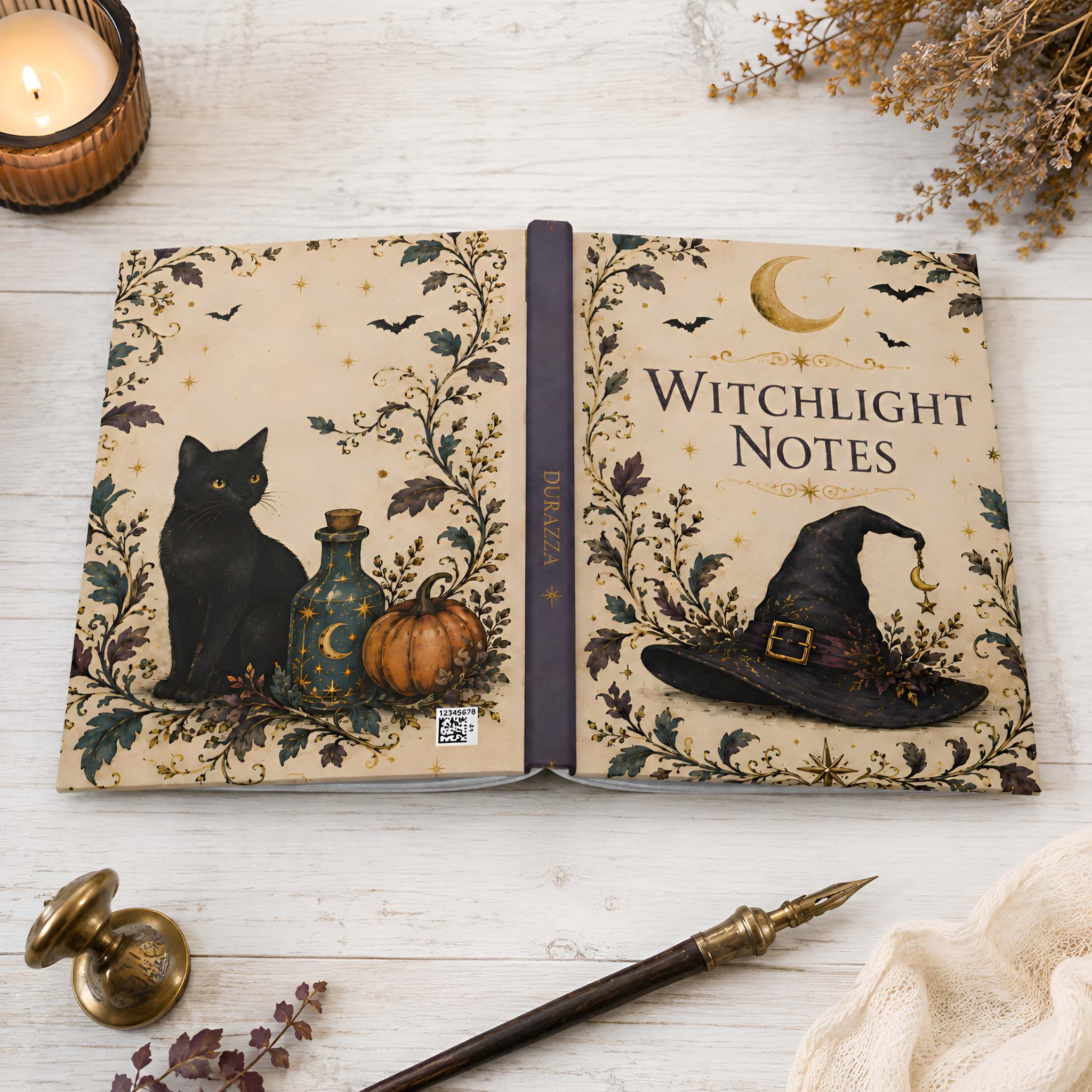 An open decorative journal titled 'Witchlight Notes' laid on a white wood surface, surrounded by a candle, dried flowers, a wand, and a small brass knob. The cover design features a black cat, a blue bottle with stars, a pumpkin, bats, a crescent moon, and a witch hat.