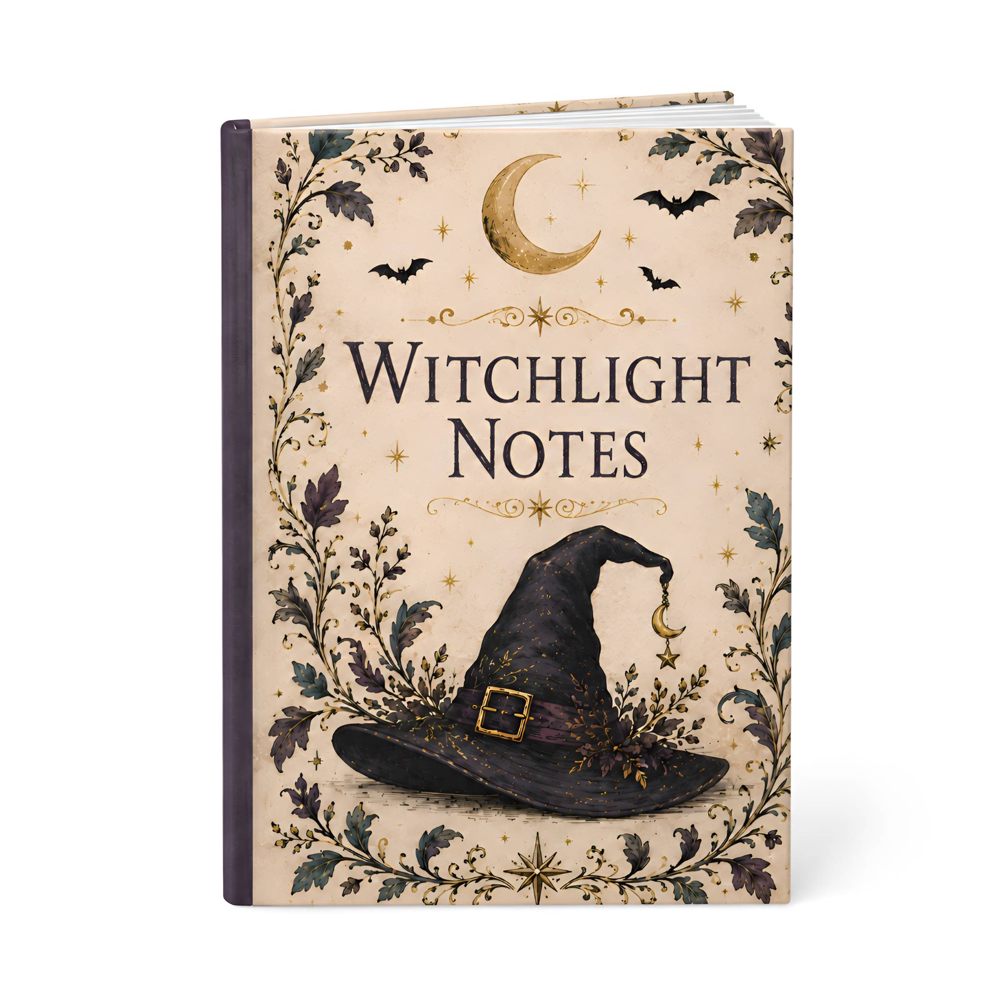 A hardcover notebook titled 'Witchlight Notes' with a cream-colored cover decorated with a black witch hat, bats, a crescent moon, and floral vines.