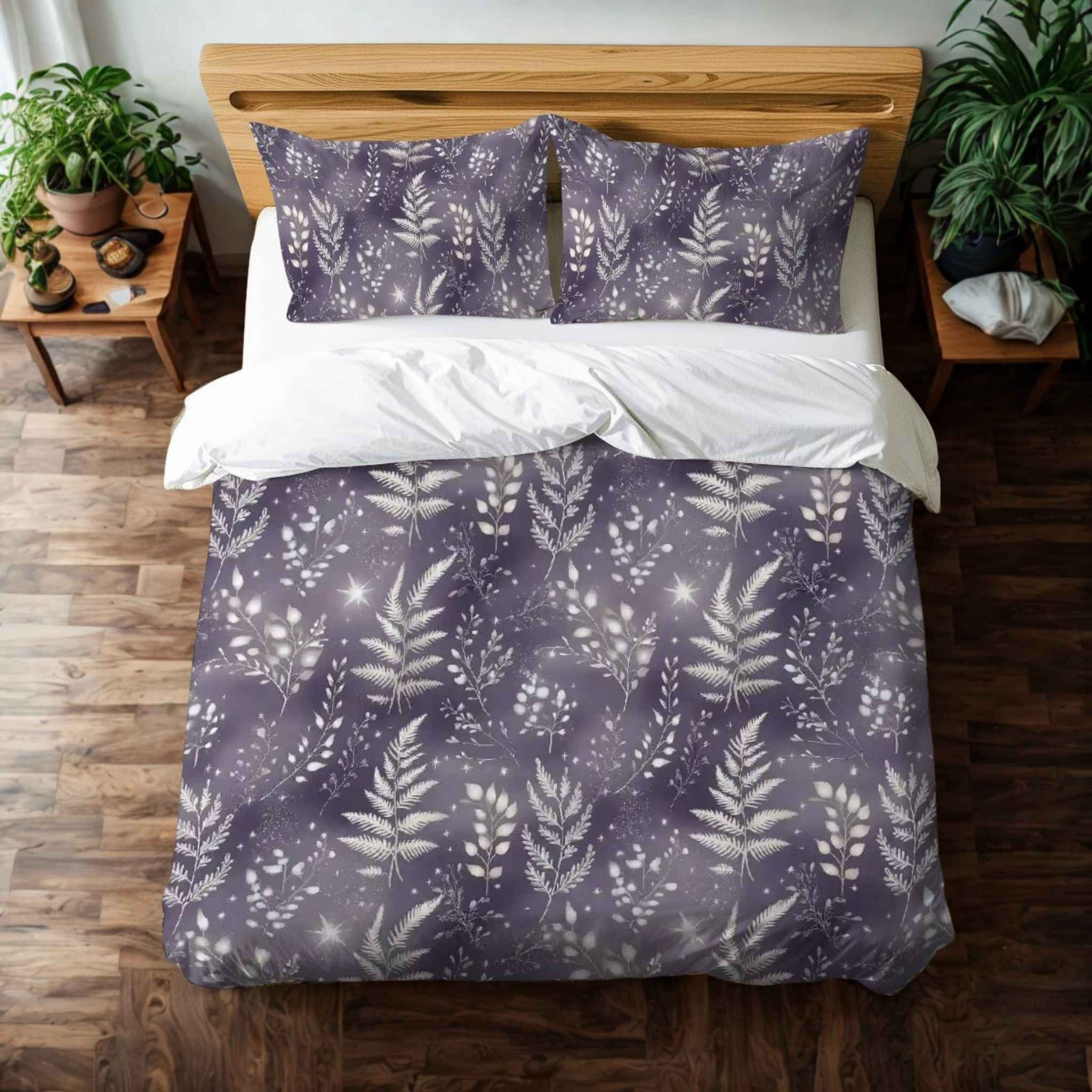 A duvet cover set with a purple and silver botanical pattern against a lavender background, displayed in a room setting with curtains and a plant.