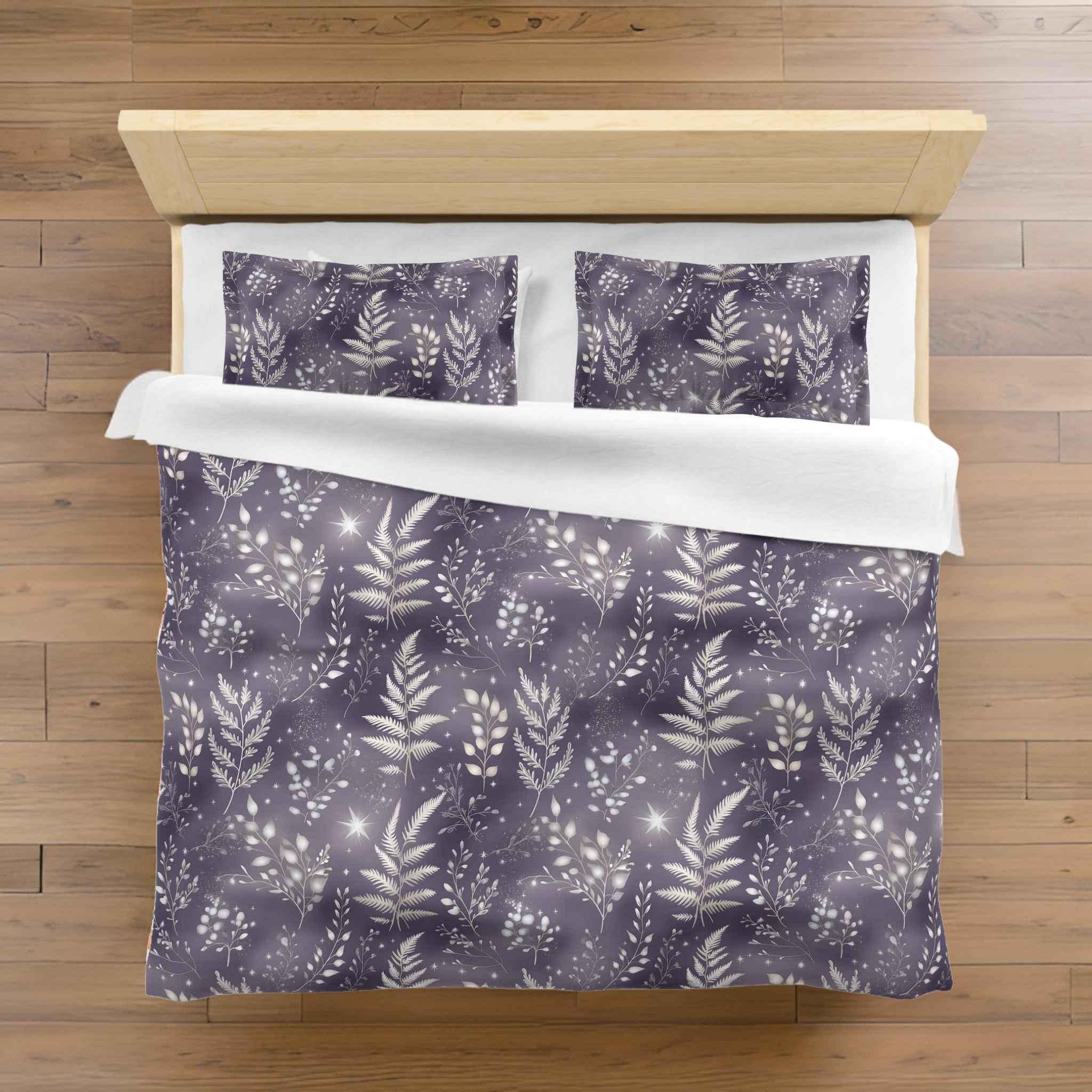 A duvet cover set with a purple and silver botanical pattern against a lavender background.