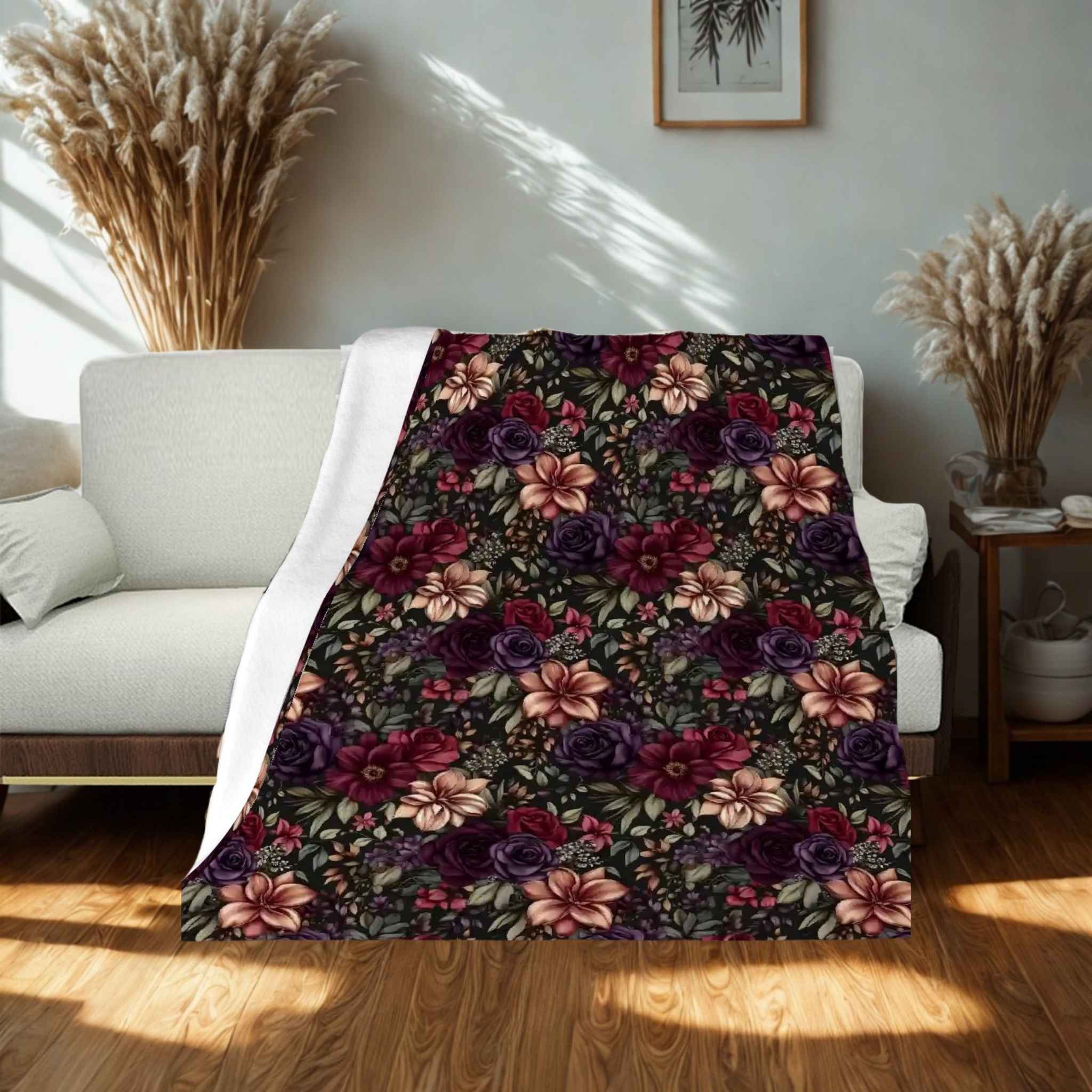 Floral patterned blanket draped over a sofa in a room with decorative elements.