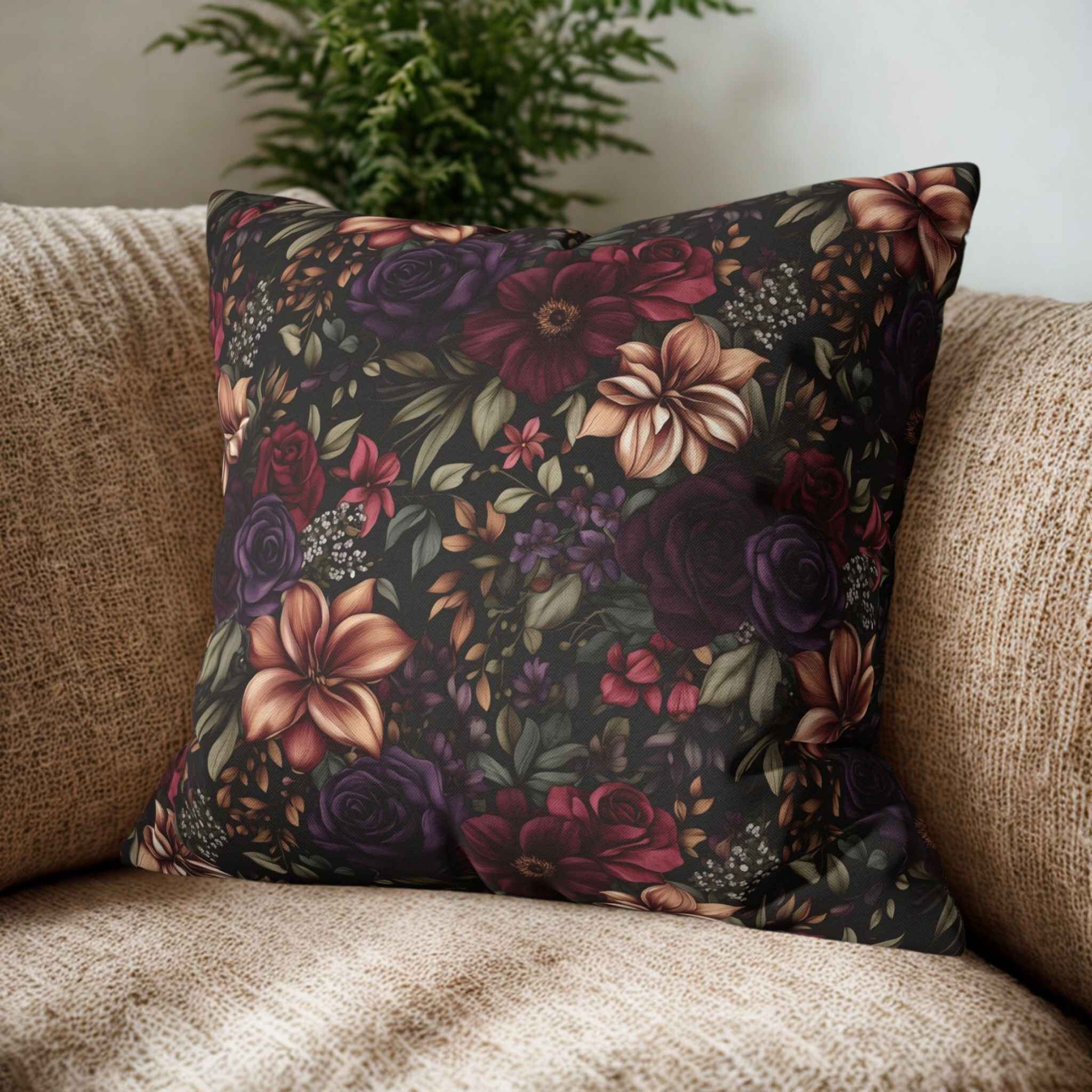 Floral-patterned pillow on a beige couch with a plant in the background