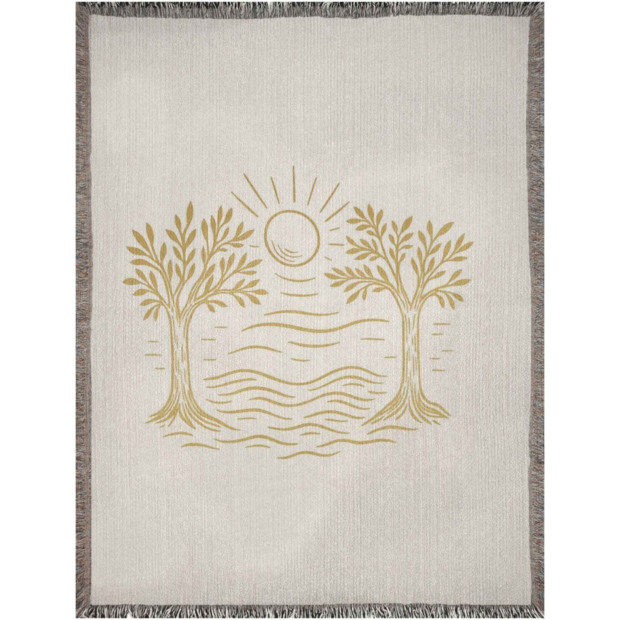 Blanket with gold tree and sun design on a beige background