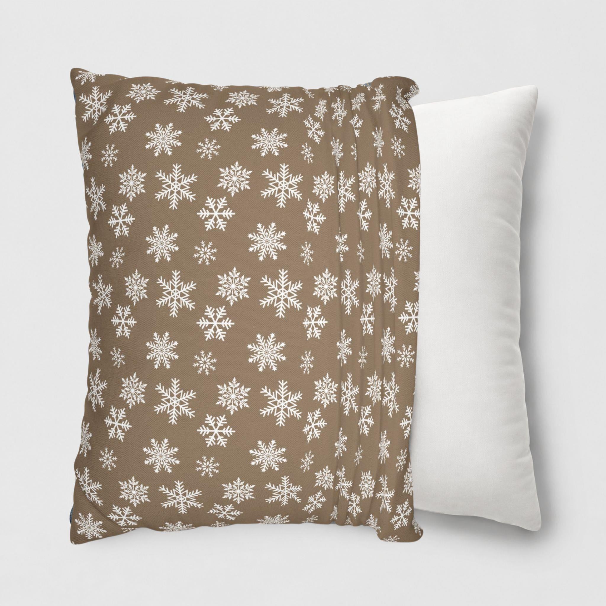A snowflake pattern throw pillow cover being put onto a throw pillow.