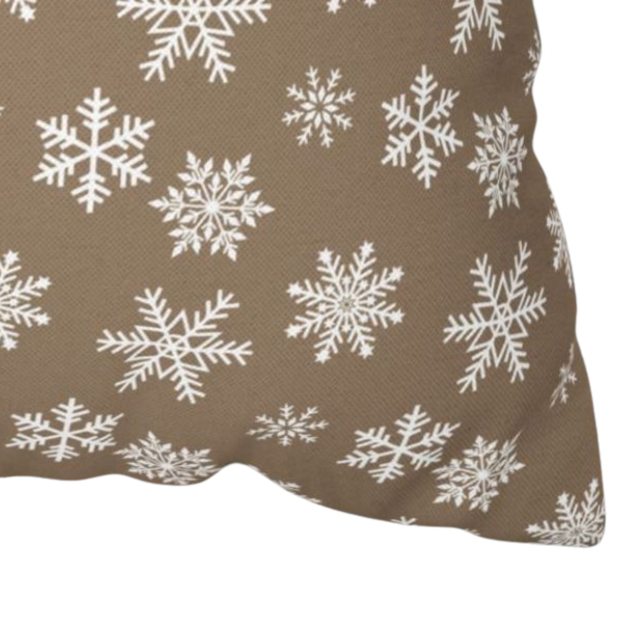 Detailed closeup of a snowflake pillow cover pattern with white flakes on taupe fabric.