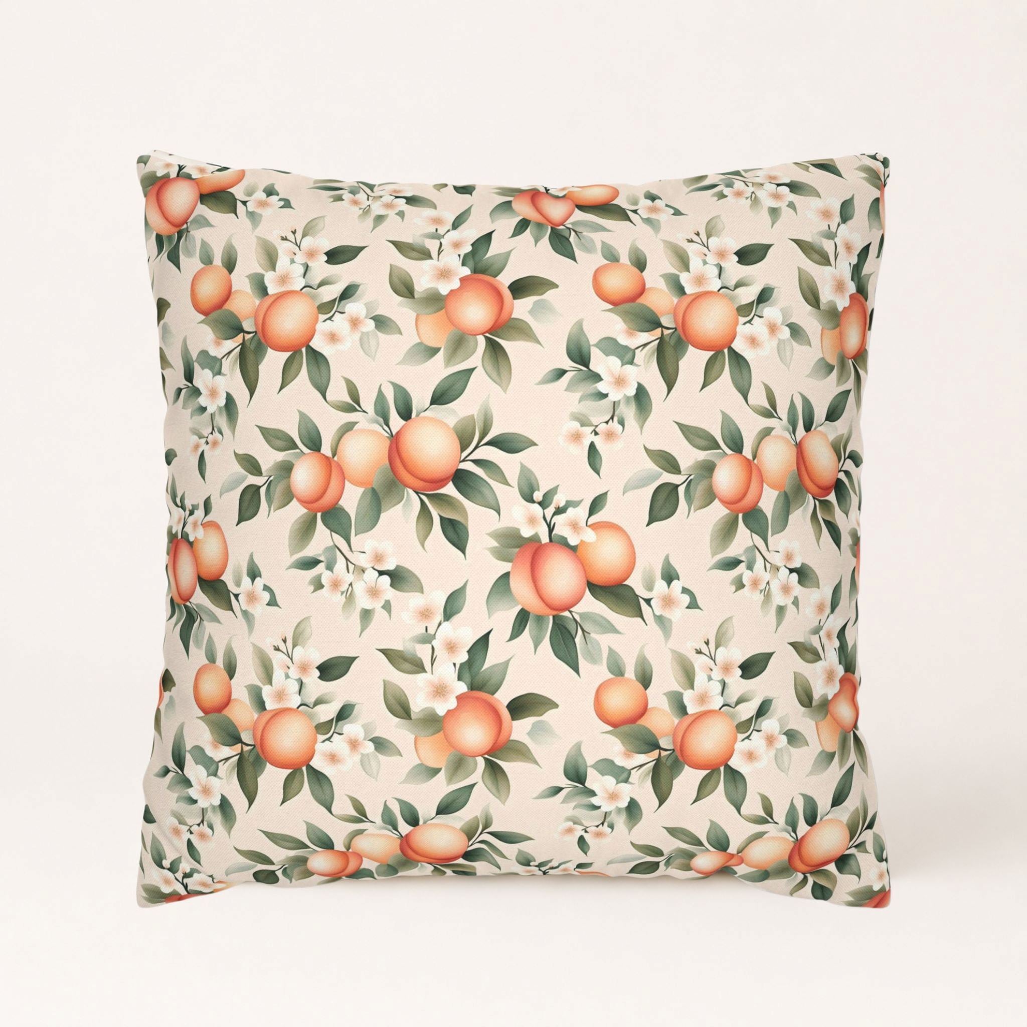 Peach floral pillow cover with peach fruit, white blossoms, and green leaves on a cream background.
