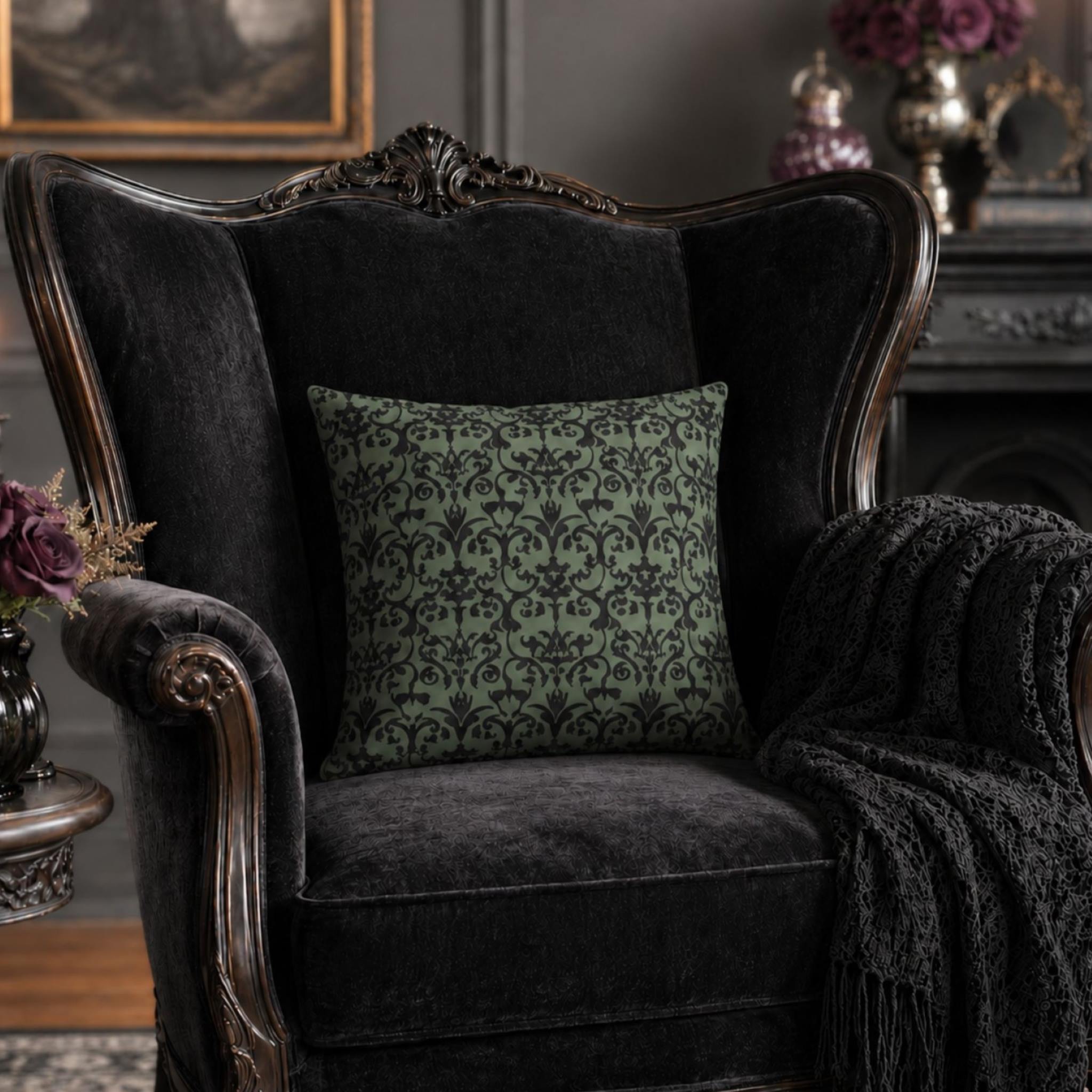 Dark upholstered armchair with a patterned green damask pillow in a Victorian gothic room setting.