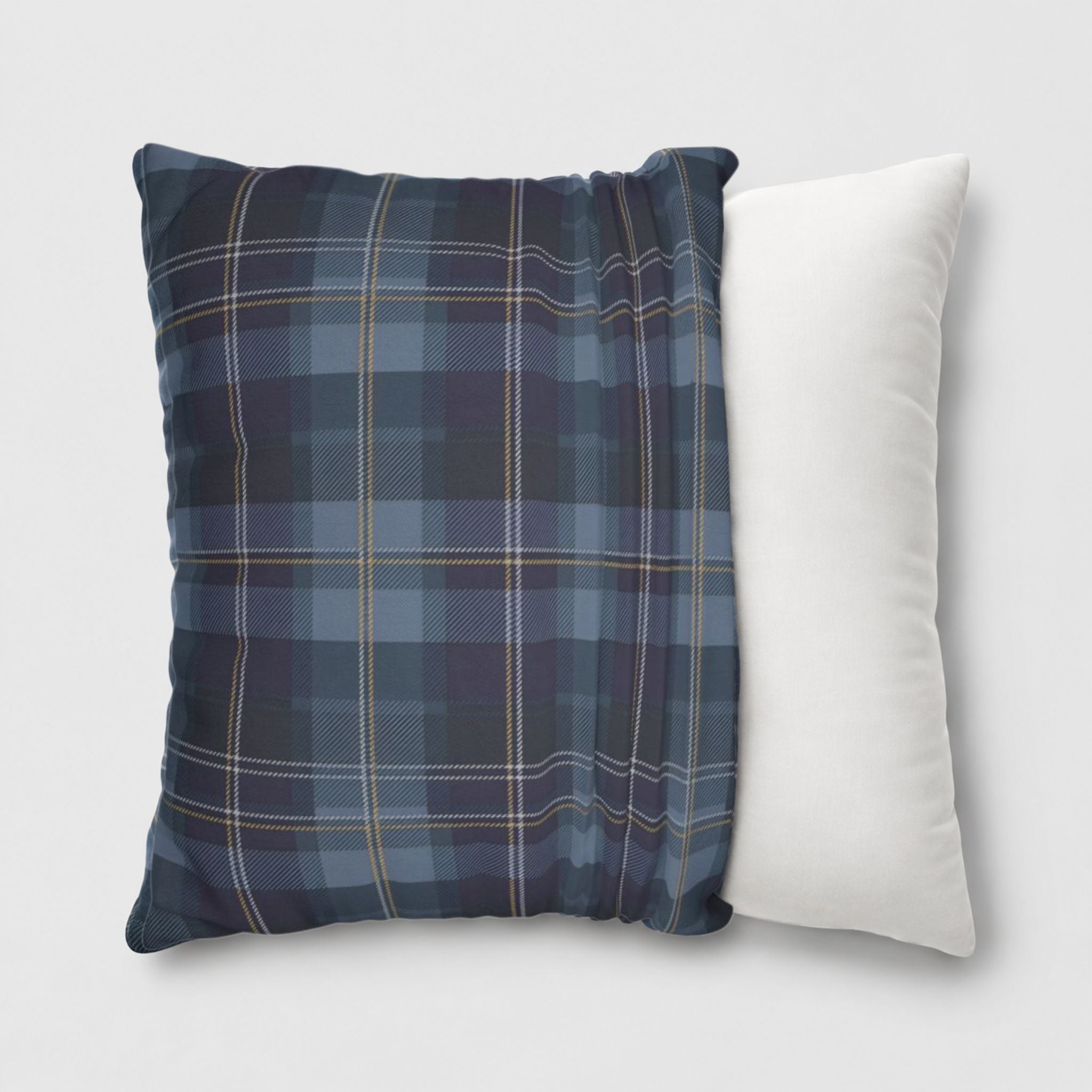Blue plaid throw pillow cover on a white pillow.