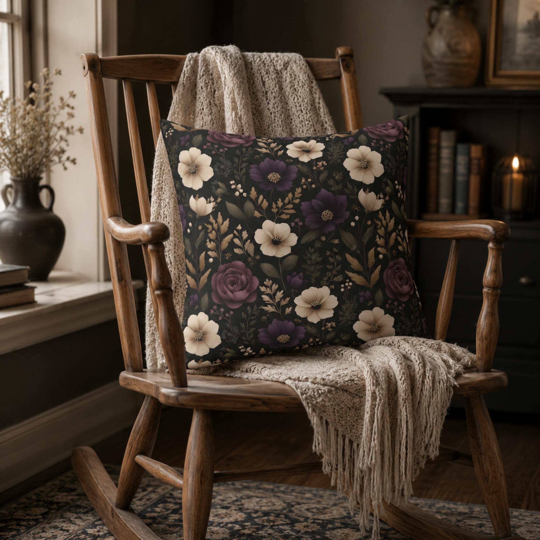 Moody ivory and plum pillow cover on a wooden chair with a blanket in a cozy room setting.