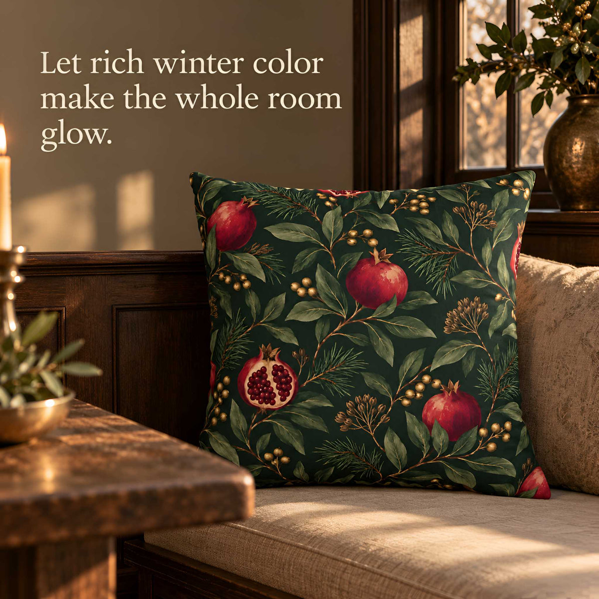 Pomegranate botanical pillow with red fruit and green foliage styled in a warm vintage dining room