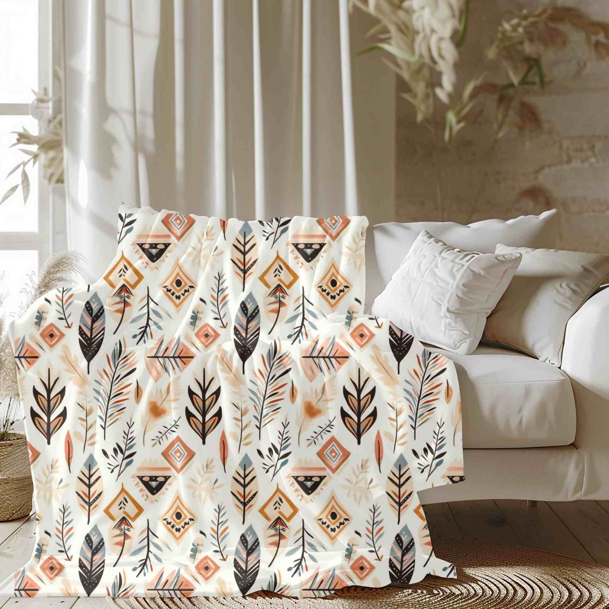 A Southwestern tribal throw blanket with painted feather patterns draped over a couch in a room with white walls and wood flooring.
