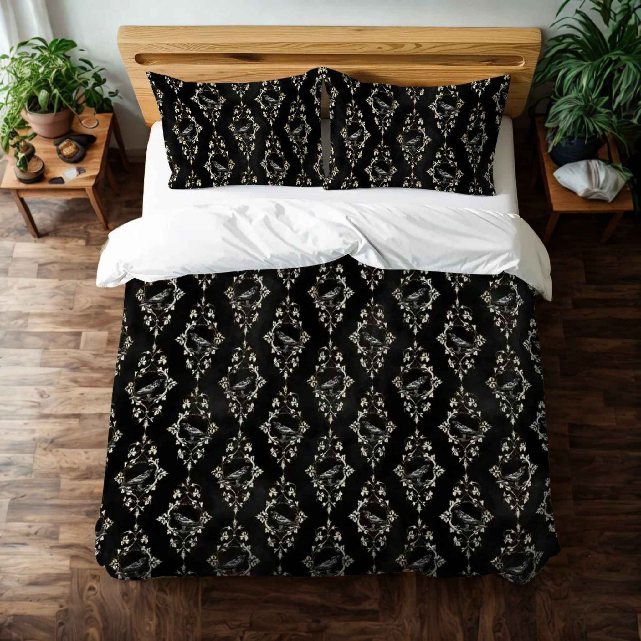 A dark academia style duvet cover with gold baroque accents displayed on a bed, featuring a raven motif and vintage filigree. Wooden floors and plants in background.