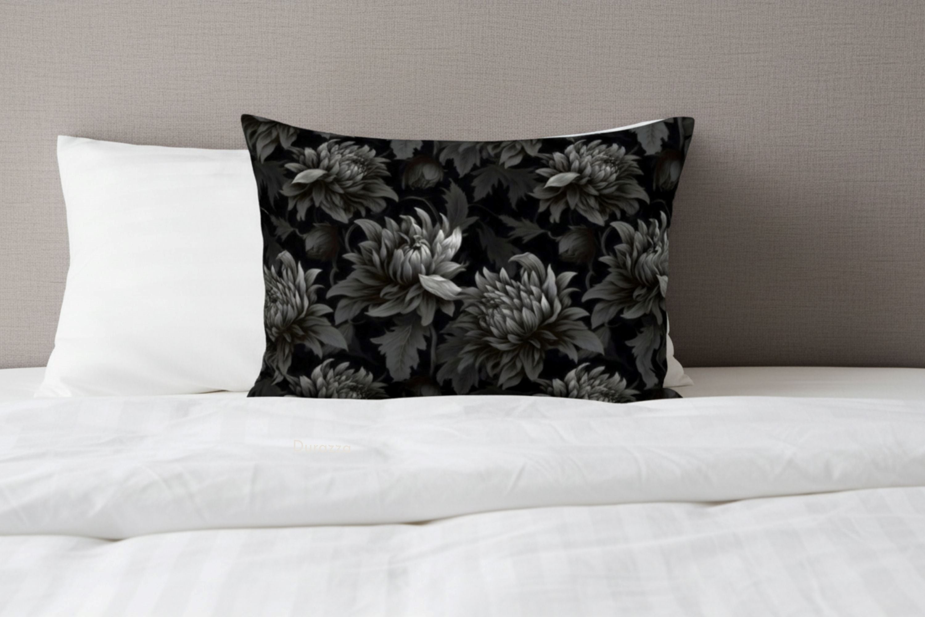 Moody Floral pillow sham on a bed with white bedding and gray wall.