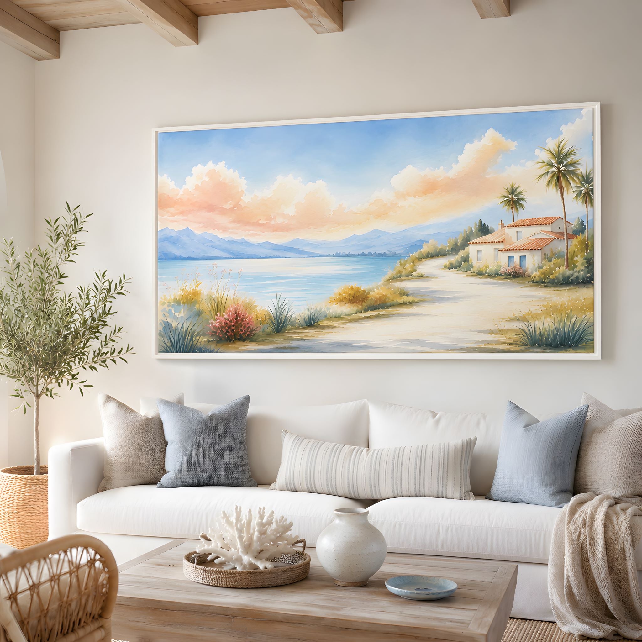 Living room with a large seaside landscape painting on the wall above a white sofa.
