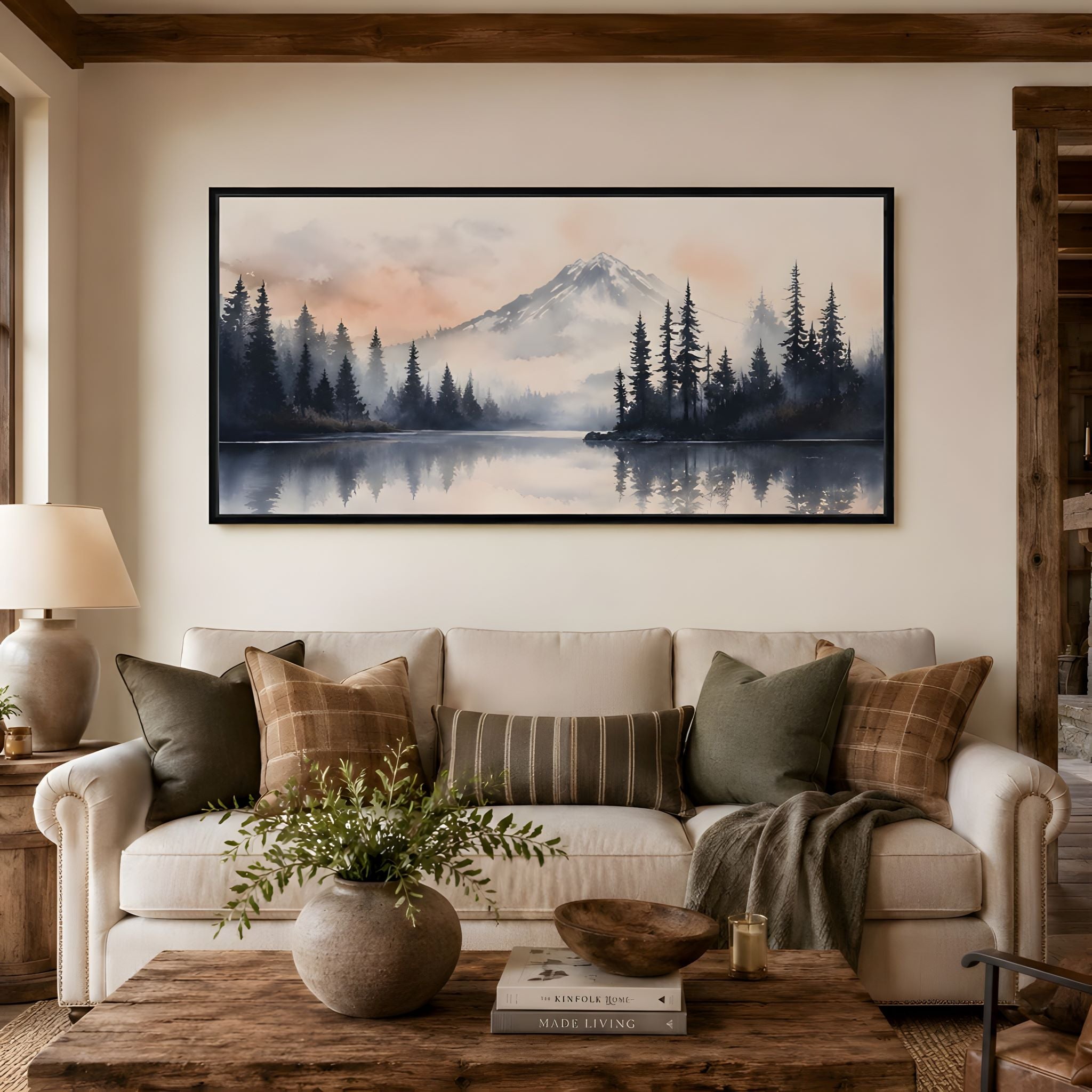 Mountain landscape canvas wall art in a living room above the sofa.