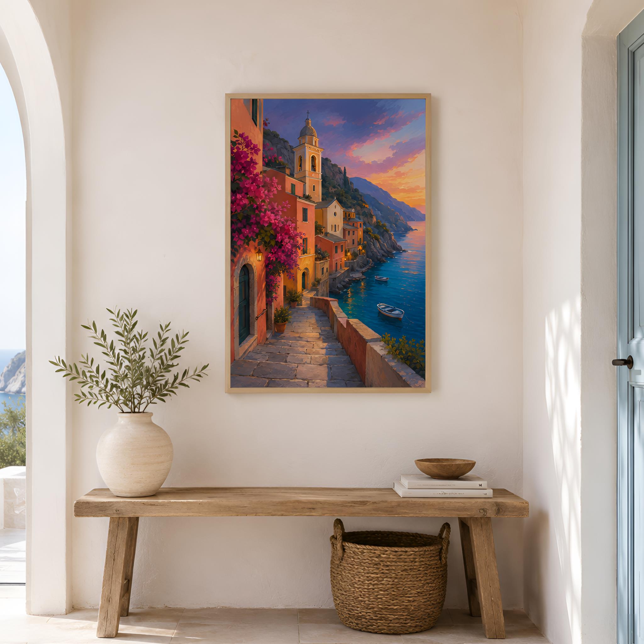 Framed colorful artwork of a Mediterranean coastal village scene above a wooden bench with decor items.