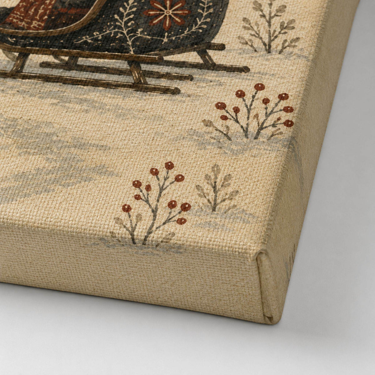 Textured canvas surface with printed design of a sled and trees on a neutral background