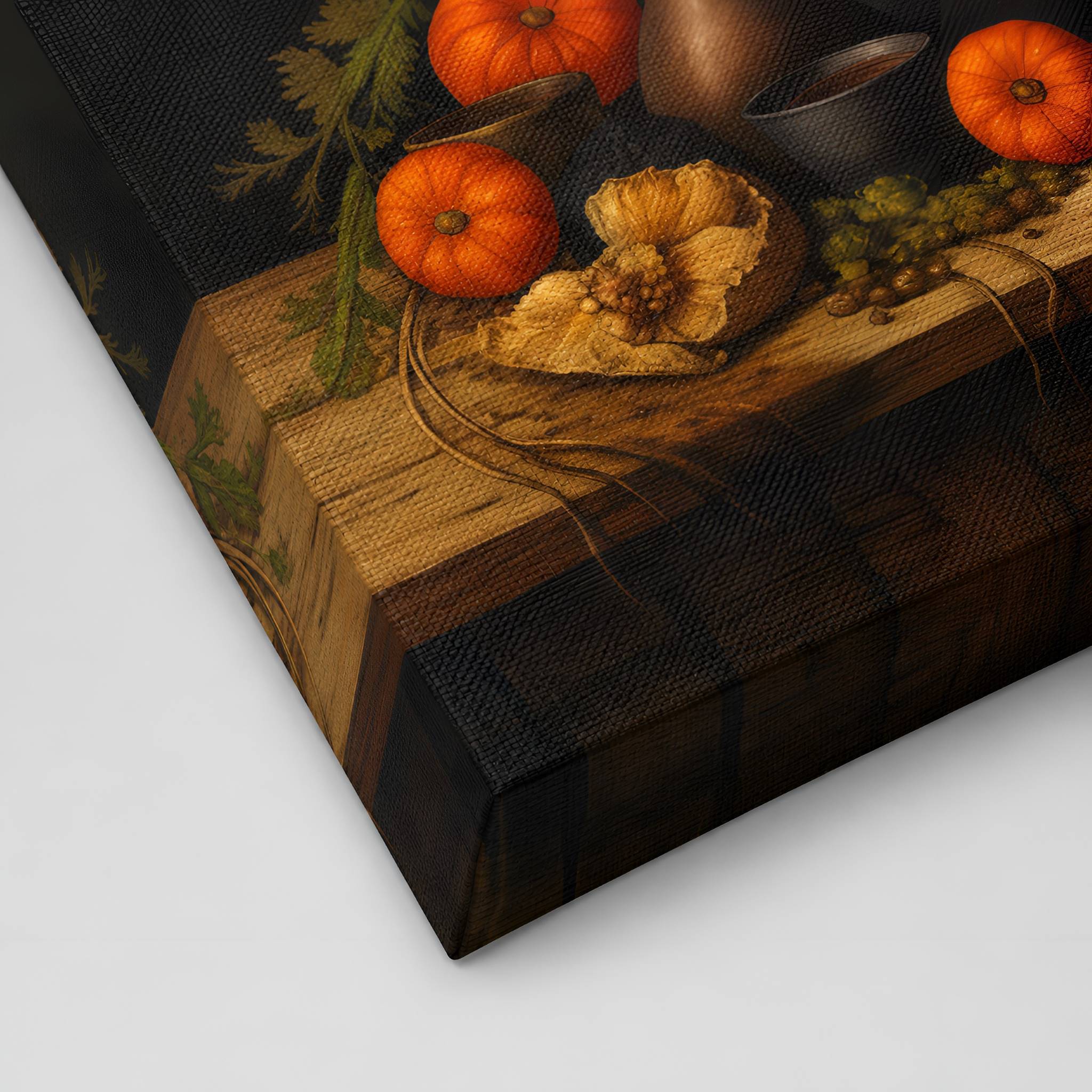 A closeup of a canvas art print of a still life scene with pumpkins and a cauldron on a wooden surface.