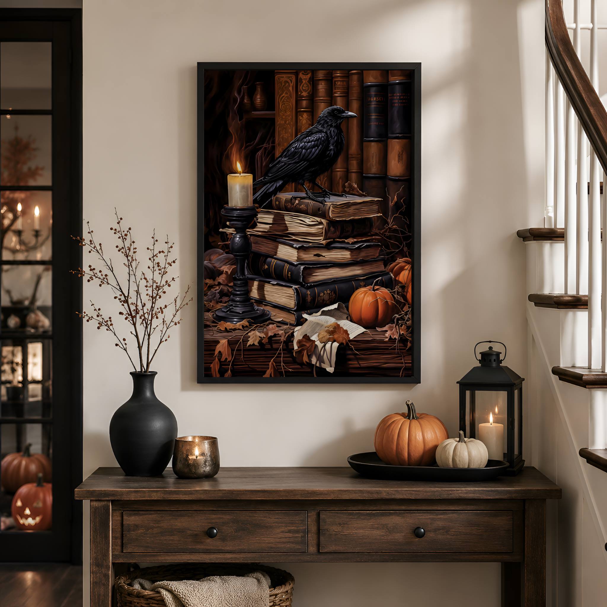 Black framed artwork of a Raven on books with pumpkins and candles on a wooden console table.