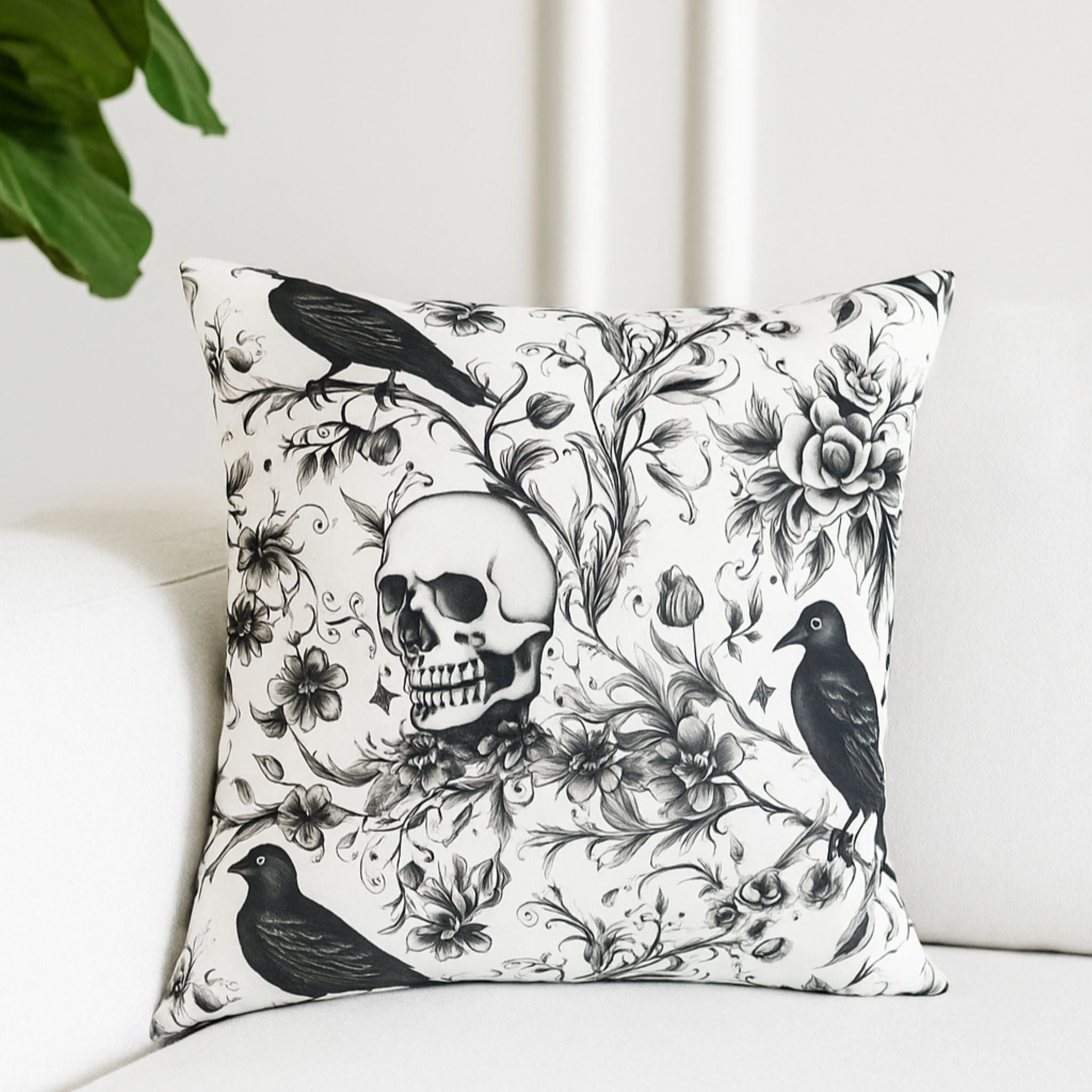Decorative pillow with skull and crow design on a white couch