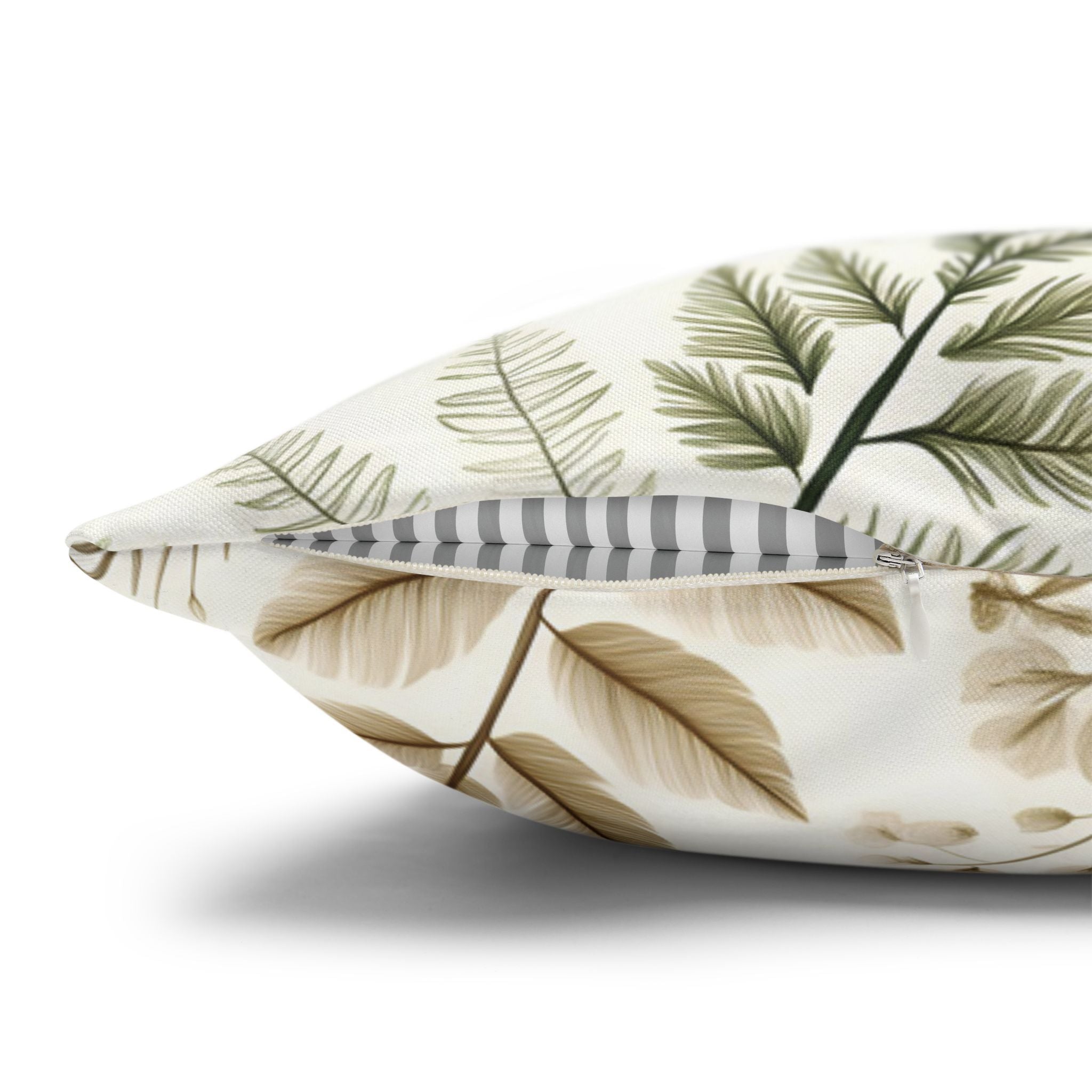 Decorative pillow with leaf pattern on a white background showing hidden zipper.