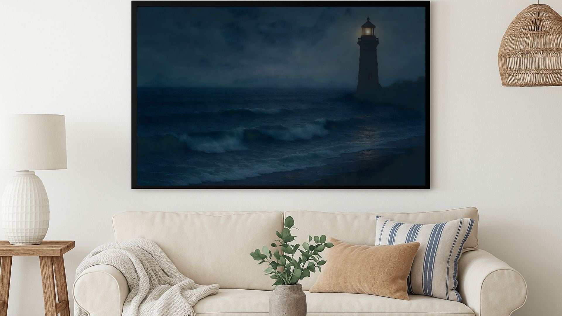 Framed lighthouse painting over beige sofa in coastal-style living room with natural light and neutral decor.