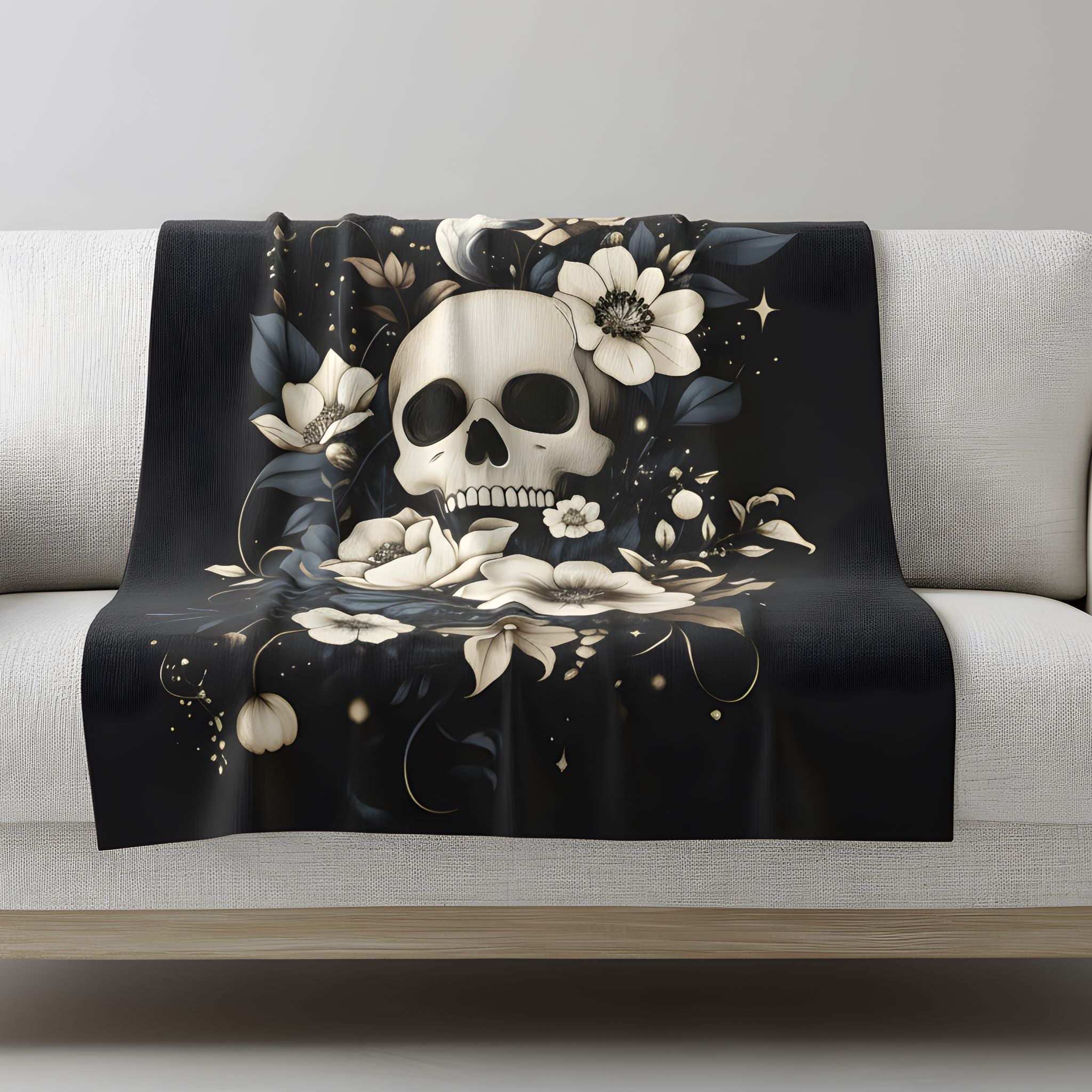 Dark floral velveteen throw blanket draped on sofa with ivory skull, star accents, and soft neutral flowers.