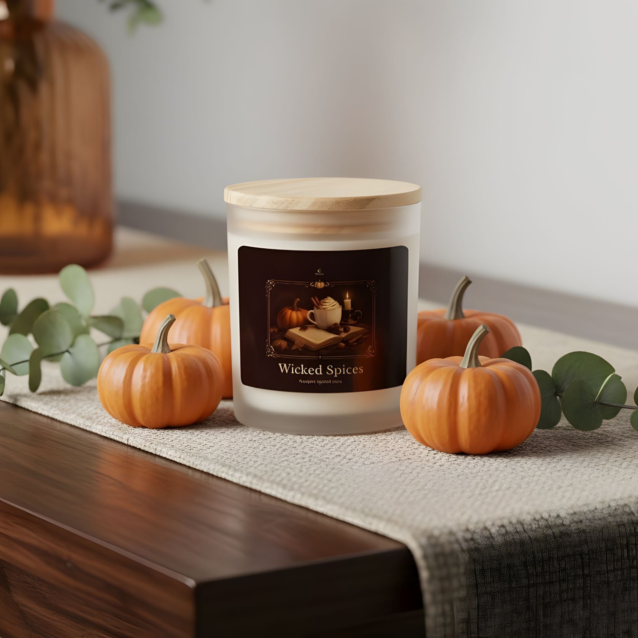 Pumpkin-spiced latte scented candle labeled 'Wicked Spices' on a Halloween table with pumpkins and eucalyptus leaves.